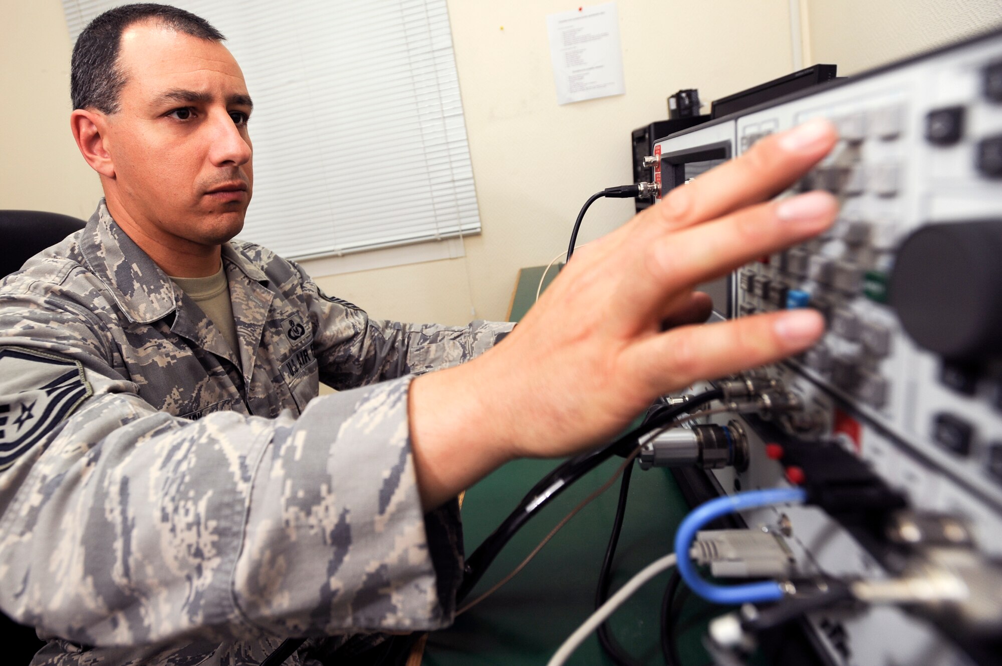 Master Sgt. David Emrich, the NCOIC for aircrew flight equipment with the 379th Expeditionary Operations Support Squadron, performs a functional test on a PRC-112 Survival Radio, Feb. 10, 2009, in an undisclosed location in Southwest Asia.  The test unit ensures different features on the radio are functioning optimally. The radio's features include a global positioning system which will pin-point the position of downed aircrew.  Sergeant Emrich is native to Roy, Utah and deployed from Offutt Air Force Base, Neb. in support of Operations Iraqi and Enduring Freedom and Combined Joint Task Force - Horn of Africa. (U.S. Air Force Photo by Staff Sgt. Joshua Garcia/released)