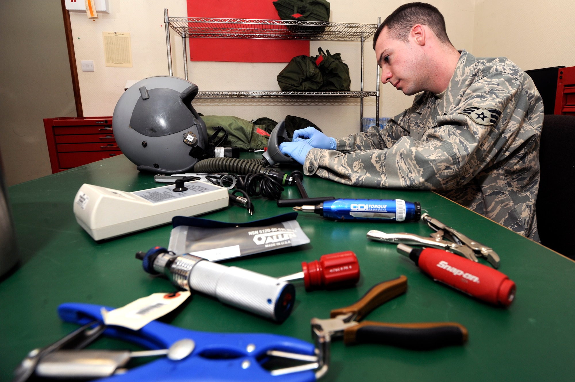 Senior Airman John Cumiskey, an aircrew flight equipment technician with the 379th Expeditionary Operations Support Squadron, performs a Periodic Maintenance Inspection on a HGU 55/P helmet, Feb. 10, 2009, in an undisclosed location in Southwest Asia.  The PMI is performed after every 90 days of use and every aspect of the helmet is checked for function.  Airman Cumiskey is native to Fairfield, Conn. and deployed from Offutt Air Force Base, Neb. in support of Operations Iraqi and Enduring Freedom and Combined Joint Task Force - Horn of Africa. (U.S. Air Force Photo by Staff Sgt. Joshua Garcia/released)