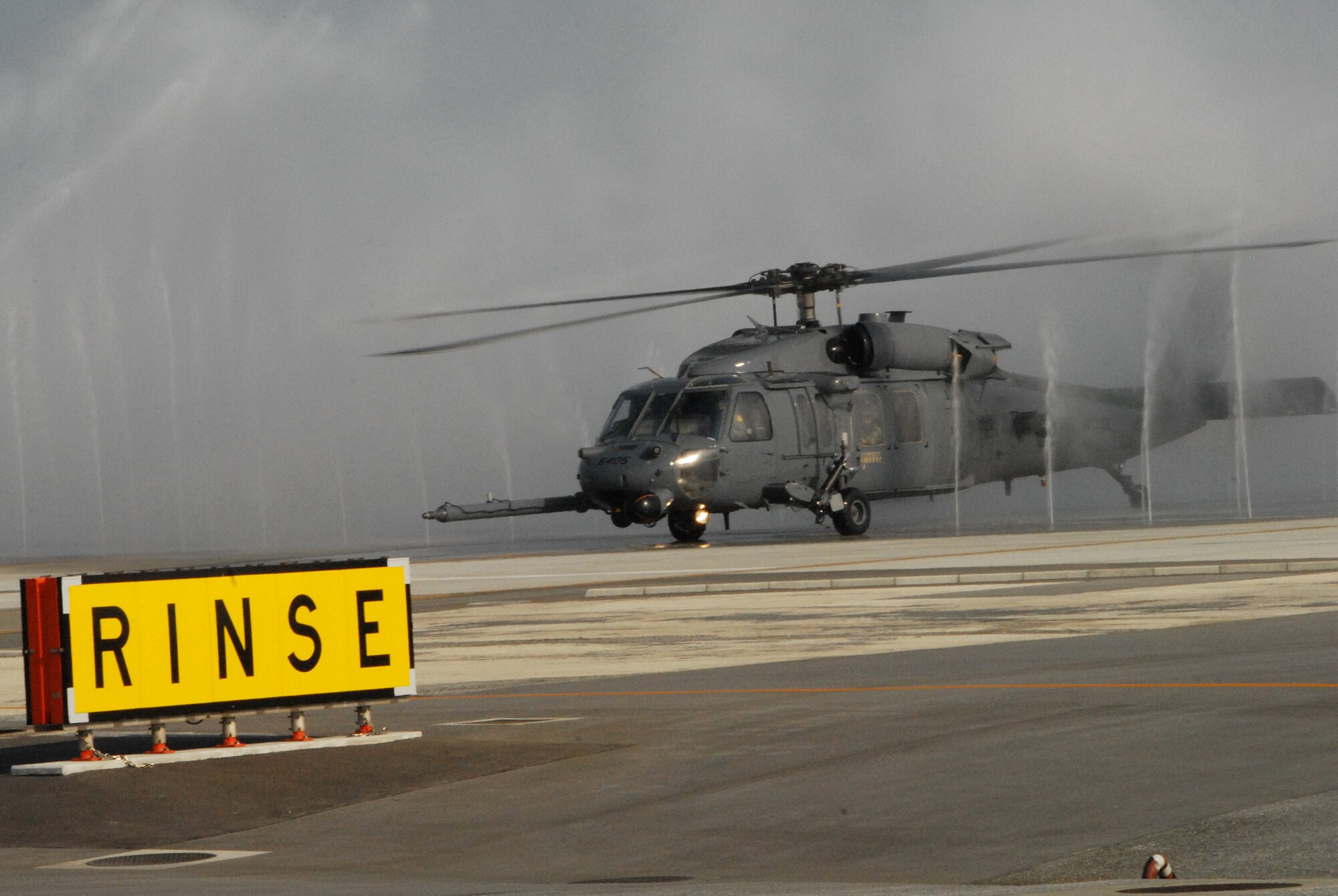 An HH-60 Pave Hawk runs through a “Bird Bath” to prevent saltwater corrosion after an air refueling mission off the coast of Okinawa, Japan as part of exercise Cope Angel 09-1. Cope Angel is a joint rescue exercise between members of the U.S. Air Force and the Japanese Air Self Defense Force. (U.S. Air Force photo/Staff Sgt Chrissy Best)