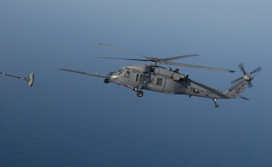 An HH-60 Pave Hawk lines ups with the C-130 drogue during an air refueling mission off the coast of Okinawa, Japan as part of exercise Cope Angel 09-1. Cope Angel is a joint rescue exercise between members of the U.S. Air Force and the Japanese Air Self Defense Force. (U.S. Air Force photo/Staff Sgt Chrissy Best)