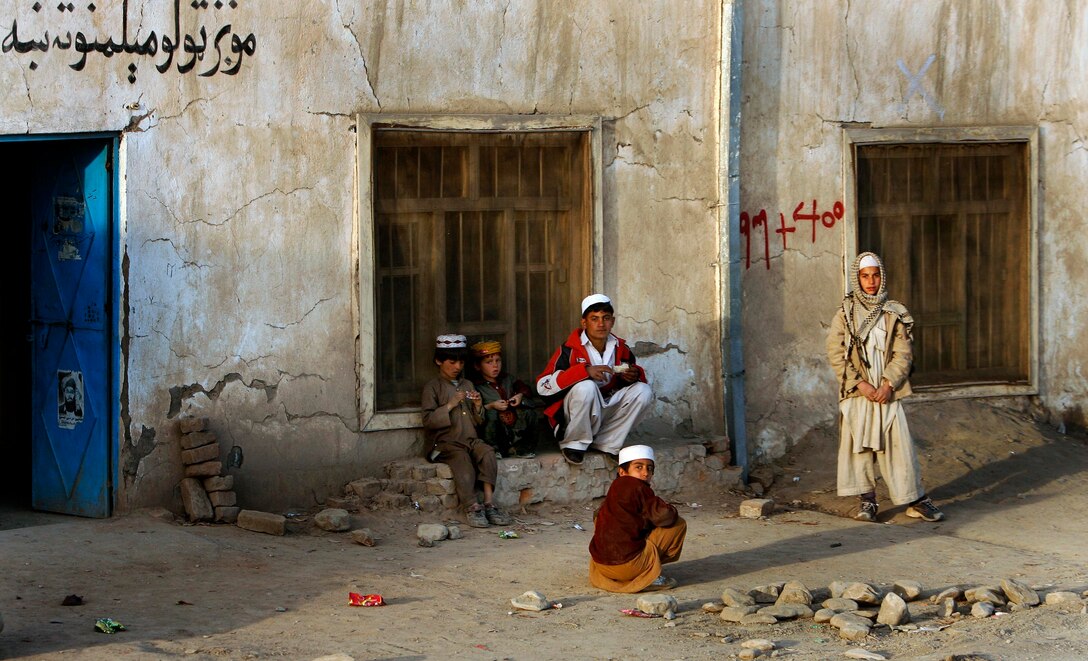 Western style running shoes bedeck some of the Afghan boys outside a building, Feb. 7, 2009. 