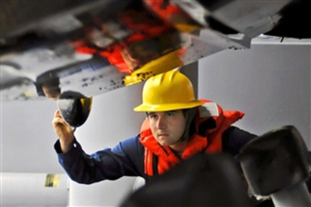 U.S. Navy Petty Officer 3rd Class Michael Jimenez directs a davit operator to seat a rigid hull inflatable boat after a practice man-overboard recovery drill in the Pacific Ocean, Feb. 9, 2009. Jiminez is assigned to the USS Blue Ridge, the flagship for Commander, U.S. 7th Fleet.
