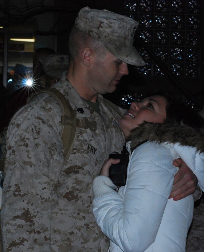 CAMP PENDLETON, Calif. (Feb. 11, 2009) -- Sgt. Michael Fry, an intelligence communicator, hugs girlfriend Catherine Coram after a year long absence during the I MEF (Fwd) homecoming ceremony here.  I MEF (Fwd) returned from a year-long deployment in Al Anbar province, Iraq supporting Operation Iraqi Freedom.