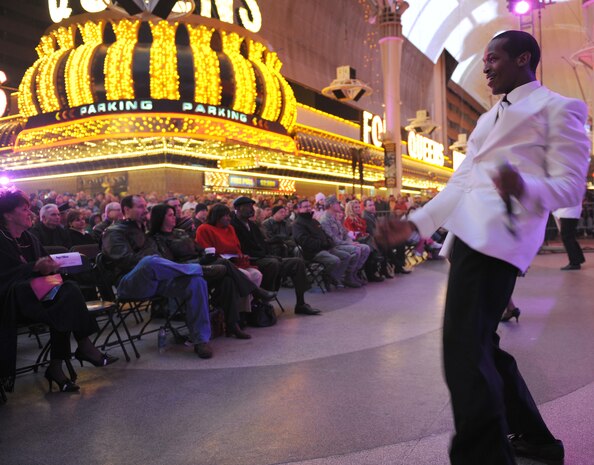 Senior Airman Quentin Thomas, a vocalist with Tops in Blue, dances to the beat before a large crowd at the Fremont Street Experience, Las Vegas, Nev., Feb. 11. Tops in Blue is an all-active duty U.S. Air Force special unit made up of talented amateur performers who perform for military personnel and their families throughout the world.(U.S. Air Force Photo/Senior Airman Larry E. Reid Jr.)