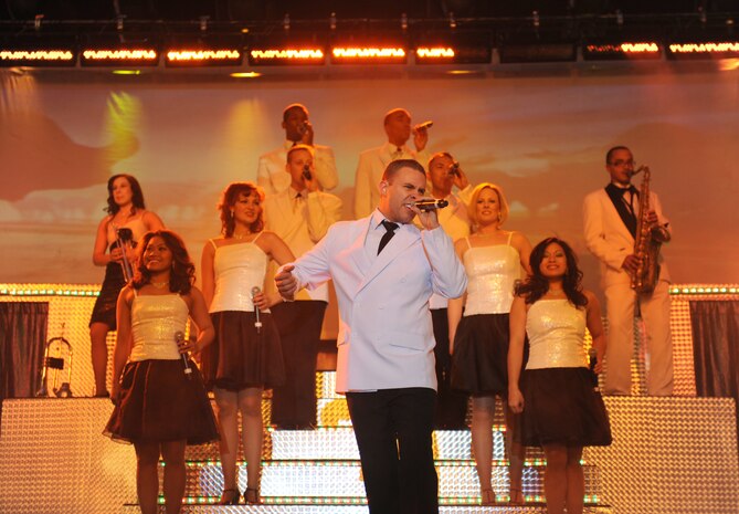 Senior Airman Nicholas Amari, a vocalist with Tops in Blue, performs before a large crowd at the Fremont Street Experience, Las Vegas, Nev., Feb. 11. Tops in Blue is an all-active duty U.S. Air Force special unit made up of talented amateur performers who perform for military personnel and their families throughout the world.(U.S. Air Force Photo/Senior Airman Larry E. Reid Jr.)
