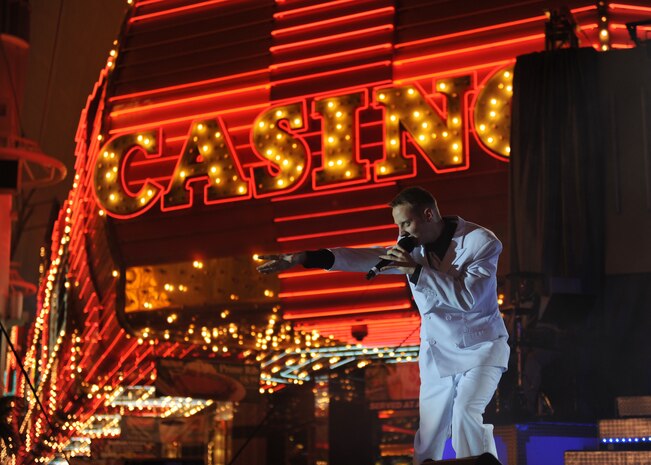 Airman 1st Class David Butler, a vocalist with Tops in Blue, performs before a large crowd at the Fremont Street Experience, Las Vegas, Nev., Feb. 11. Tops in Blue is an all-active duty U.S. Air Force special unit made up of talented amateur performers who perform for military personnel and their families throughout the world.(U.S. Air Force Photo/Senior Airman Larry E. Reid Jr.)