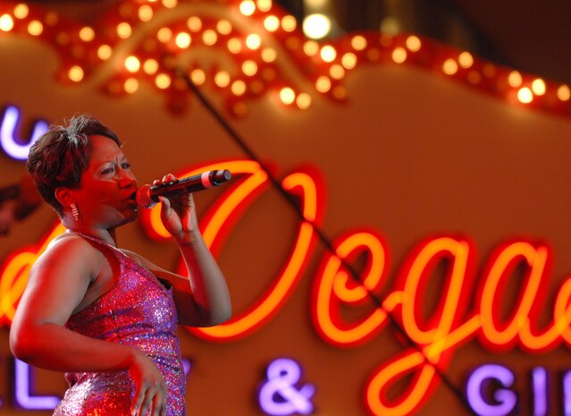 Airman 1st Class Alice Lewis, a vocalist with Tops in Blue, performs before a large crowd at the Fremont Street Experience, Las Vegas, Nev., Feb. 11. Tops in Blue is an all-active duty U.S. Air Force special unit made up of talented amateur performers who perform for military personnel and their families throughout the world.(U.S. Air Force Photo/Senior Airman Larry E. Reid Jr.)