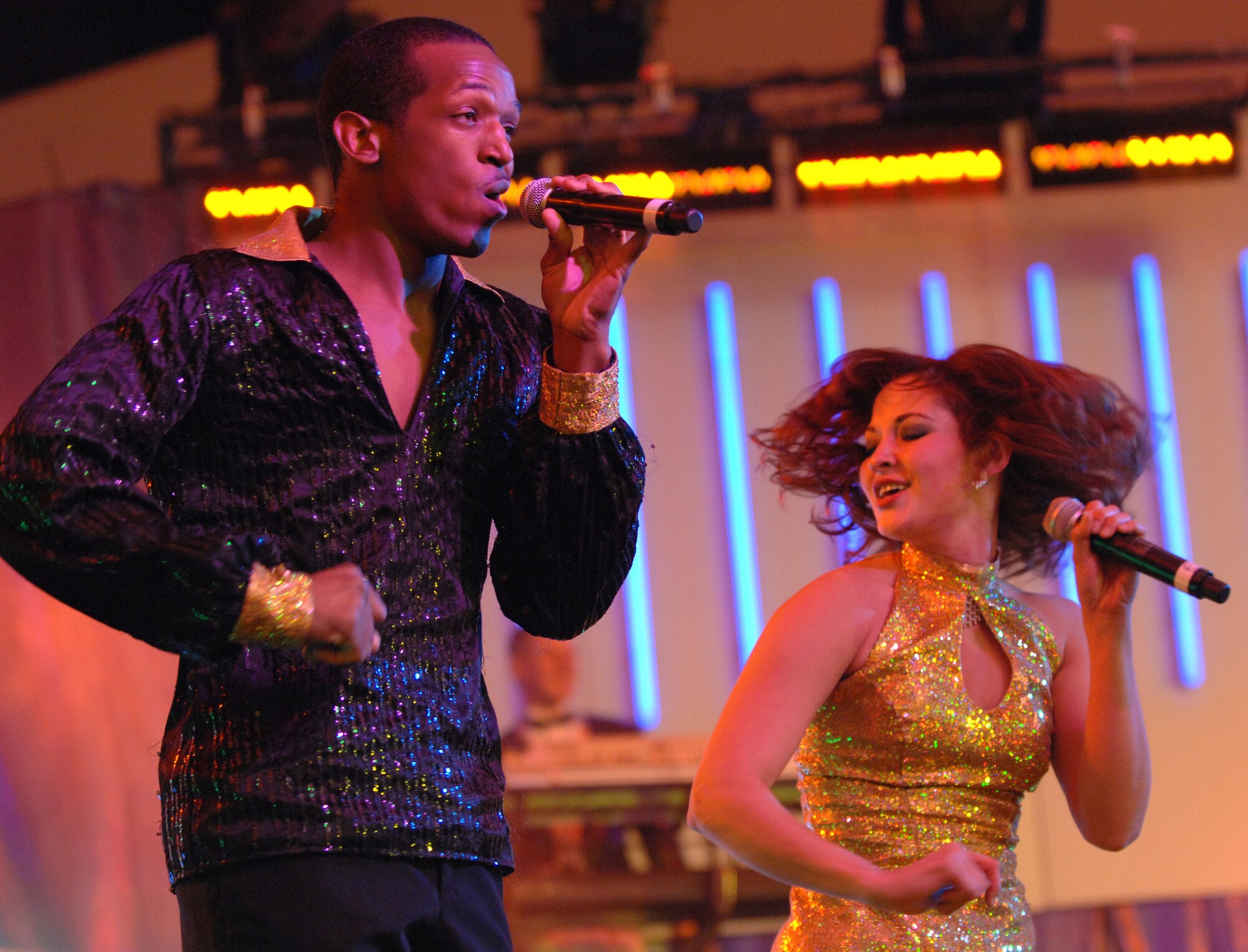 Senior Airman Quentin Thomas and 2nd Lt. Rhoda Lazo, both vocalists with Tops in Blue, perform before a large crowd at the Fremont Street Experience, Las Vegas, Nev., Feb. 11. Tops in Blue is an all-active duty U.S. Air Force special unit made up of talented amateur performers who perform for military personnel and their families throughout the world.
(U.S. Air Force Photo/Senior Airman Larry E. Reid Jr.)