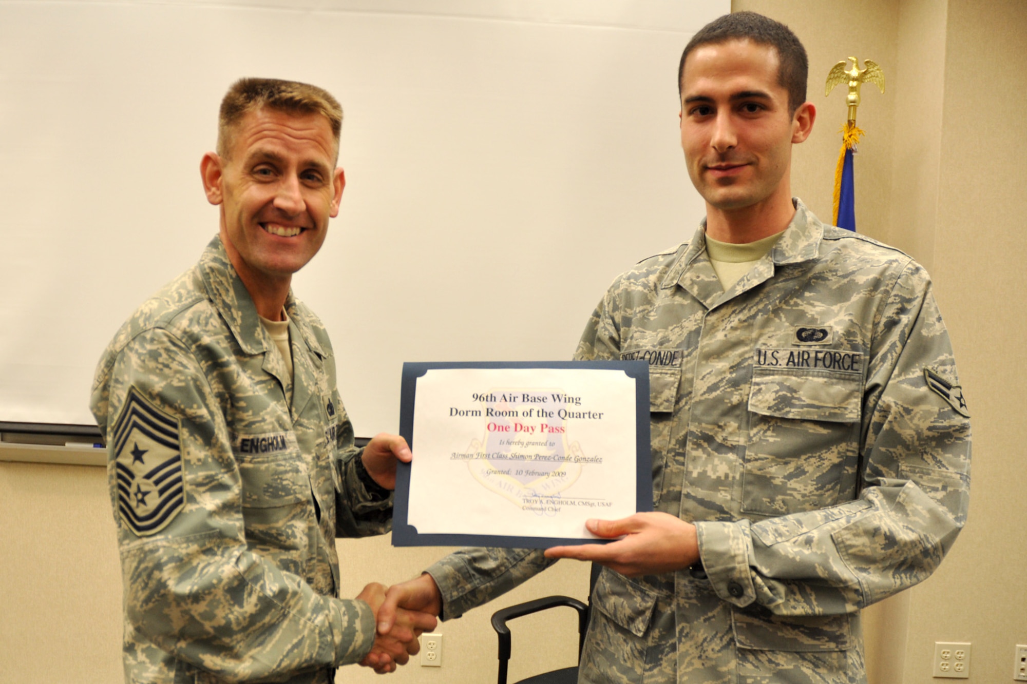 EGLIN AIR FORCE BASE, Fla. -- Contracting specialist, Airman 1st Class Shimon Perez-Conde Gonzales, 96th Contracting Squadron, recently received a visit from Chief Master Sgt. Troy Engholm, 96th Air Base Wing command chief, who presented him with the Dorm of the Quarter Award, for excellence in maintenance of his personal living quarters. (U.S. Air Force photo/ Airman Anthony Jennings)