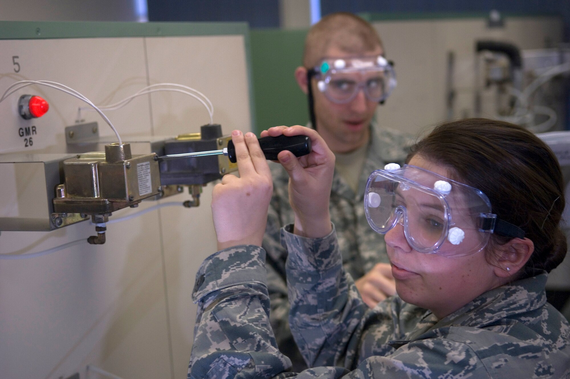 VANDENBERG AIR FORCE BASE, Calif. --  Airmen Basic Kyle Bean, left, and Airman Basic Ashley Lechner, both technical school students at the 532nd Training Squadron here, conduct hands-on training for the environmental control system of a missile launch facility. Missile maintenance technical training now takes place entirely at Vandenberg since the school house integrated electronic principles training Jan. 5. (U.S. Air Force photo/Staff Sgt. Vanessa Valentine)