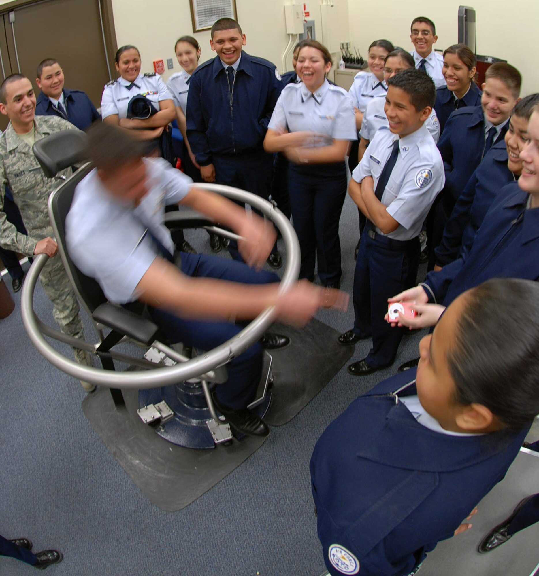 LAUGHLIN AIR FORCE BASE, Texas –Airman Rory Hayes demonstrates how to use the 'Barany chair' to a group of Del Rio High School Junior Reserve Officer Corps students during their day-long tour of Laughlin Feb. 11. This particular chair is used by pilots to train for air sickness and spatial disorientation training. (U.S. Air Force photo by Airman 1st Class Sara Csurilla)