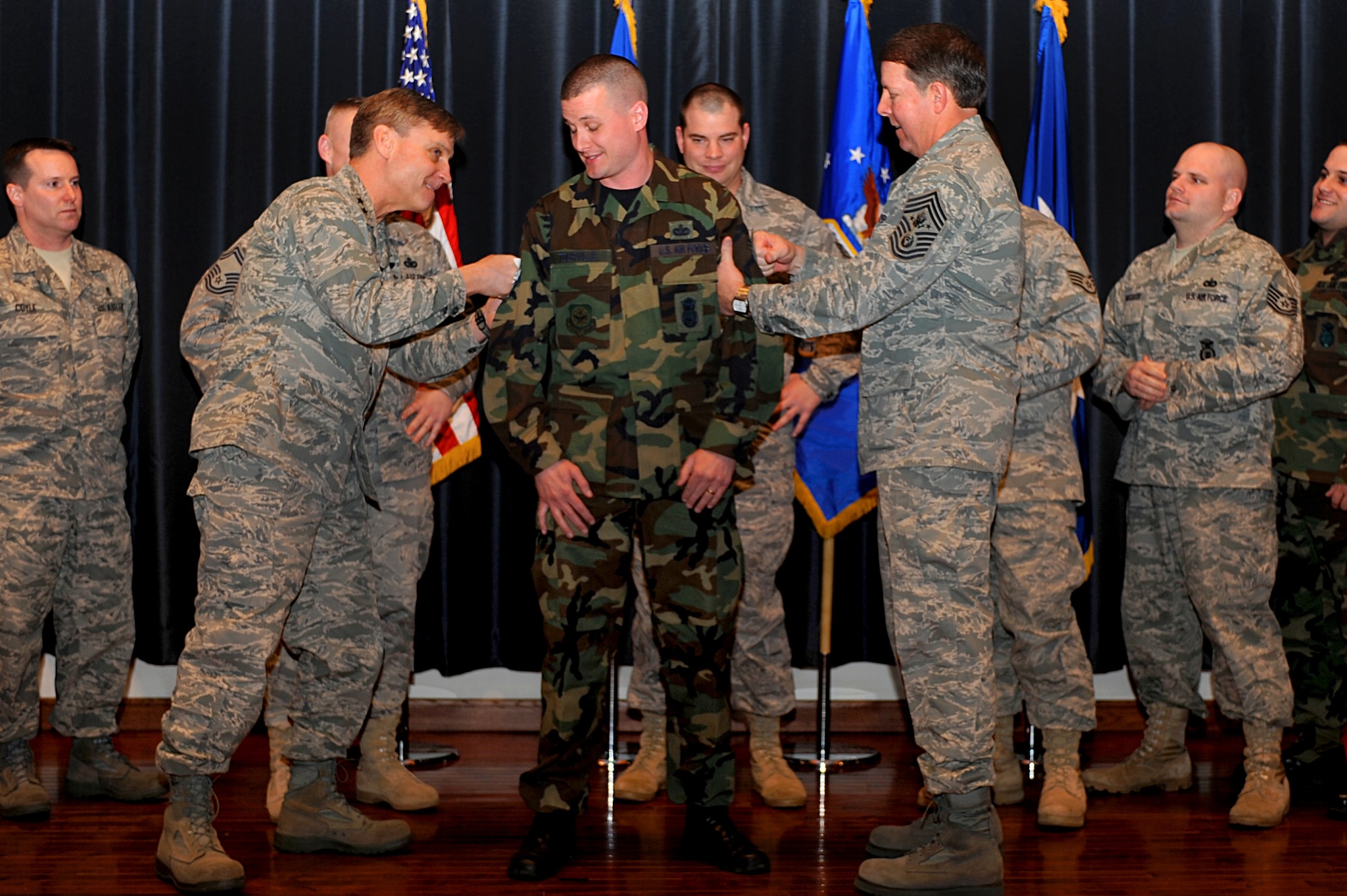 Tech. Sgt. Jonathan Tourville, 421st Combat Training Squadron assistant NCO in charge of the Advanced Contingency Skills Training Course, gets new technical sergeant stripes tacked on by Maj. Gen. Kip Self, U.S. Air Force Expeditionary Center commander, and Chief Master Sgt. of the Air Force Rodney McKinley during Chief McKinley’s visit to the Expeditionary Center on Fort Dix, N.J., Feb. 10, 2009. Sergeant Tourville was promoted to technical sergeant through the Stripes for Exceptional Performers Program by General Self.  (U.S. Air Force Photo/Staff Sgt. Nathan Bevier)