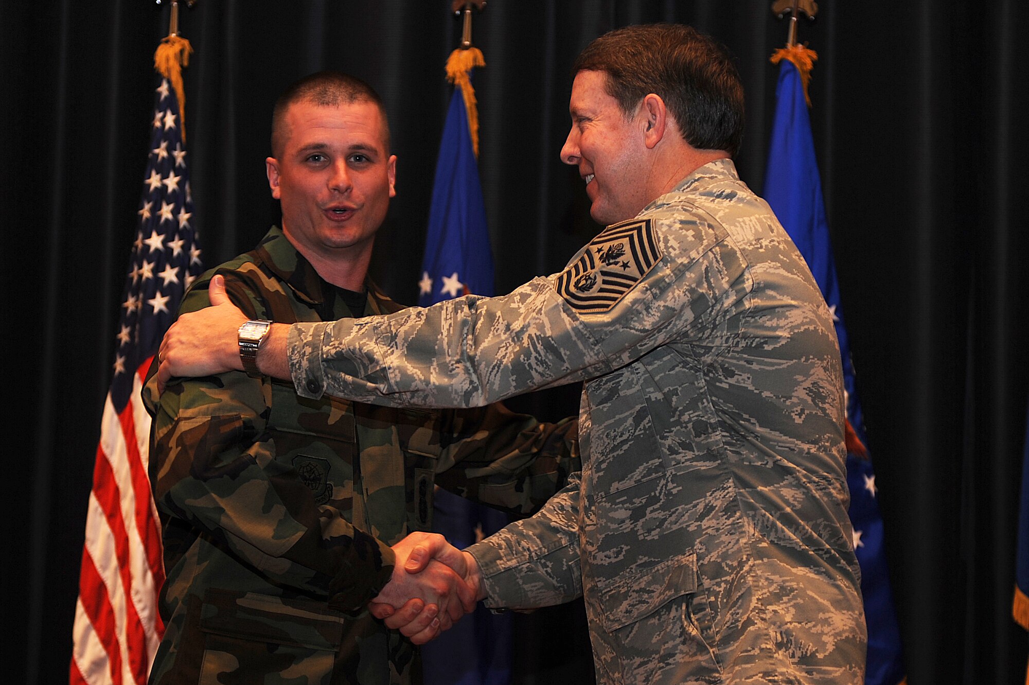 Staff Sgt. Jonathan Tourville, 421st Combat Training Squadron assistant NCO in charge of the Advanced Contingency Skills Training Course, shakes hands with Chief Master Sgt. of the Air Force Rodney McKinley during Chief McKinley’s visit to the Expeditionary Center at Fort Dix, N.J., Feb. 10, 2009. Sergeant Tourville was promoted to technical sergeant through the Stripes for Exceptional Performers Program by Maj. Gen. Kip Self, U.S. Air Force Expeditionary Center commander.  (U.S. Air Force Photo/Staff Sgt. Nathan Bevier)