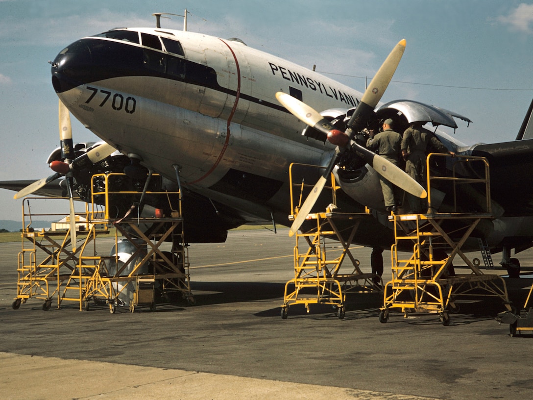 A maintenance crew of the 140th Aeromedical Transport Group Pennsylvania Air National Guard works on the engines of this C-46 Commando at Spaatz Field, Reading, Pa. March, 1958.  The C-46 nicknamed "the Jug" was the first prop engine plane of the 140th.