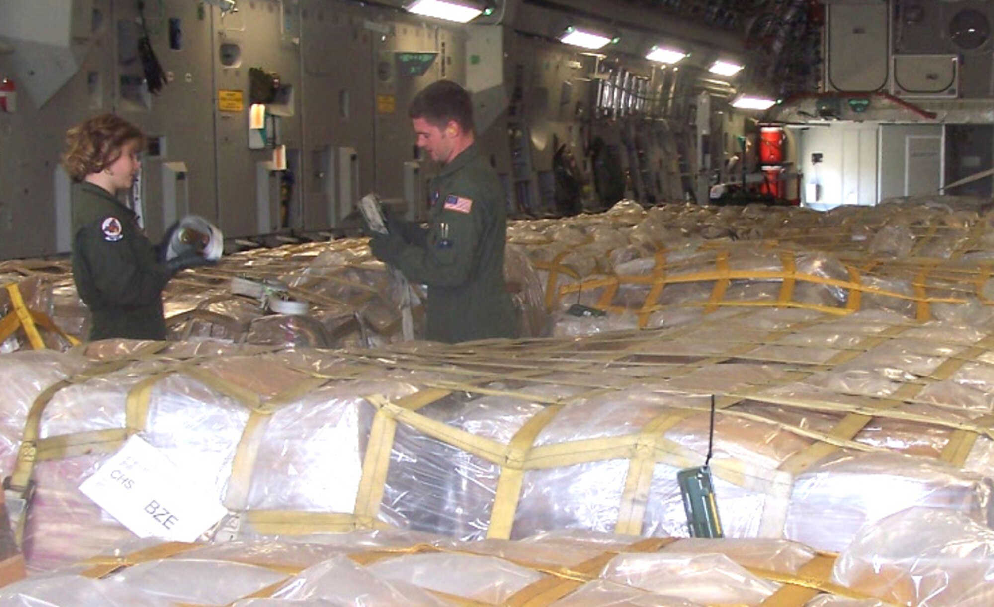 Loadmasters with the 701st Airlift Squadron, Charleston Air Force Base, S.C., prepare to unload humanitarian cargo meant for children in Belize. The Denton Amendment allows the U.S. military to transport on a space-available basis humanitarian supplies from non-governmental organizations to people around the world who are in need. (U.S. Air Force photo/Maj. Derek Bishop)