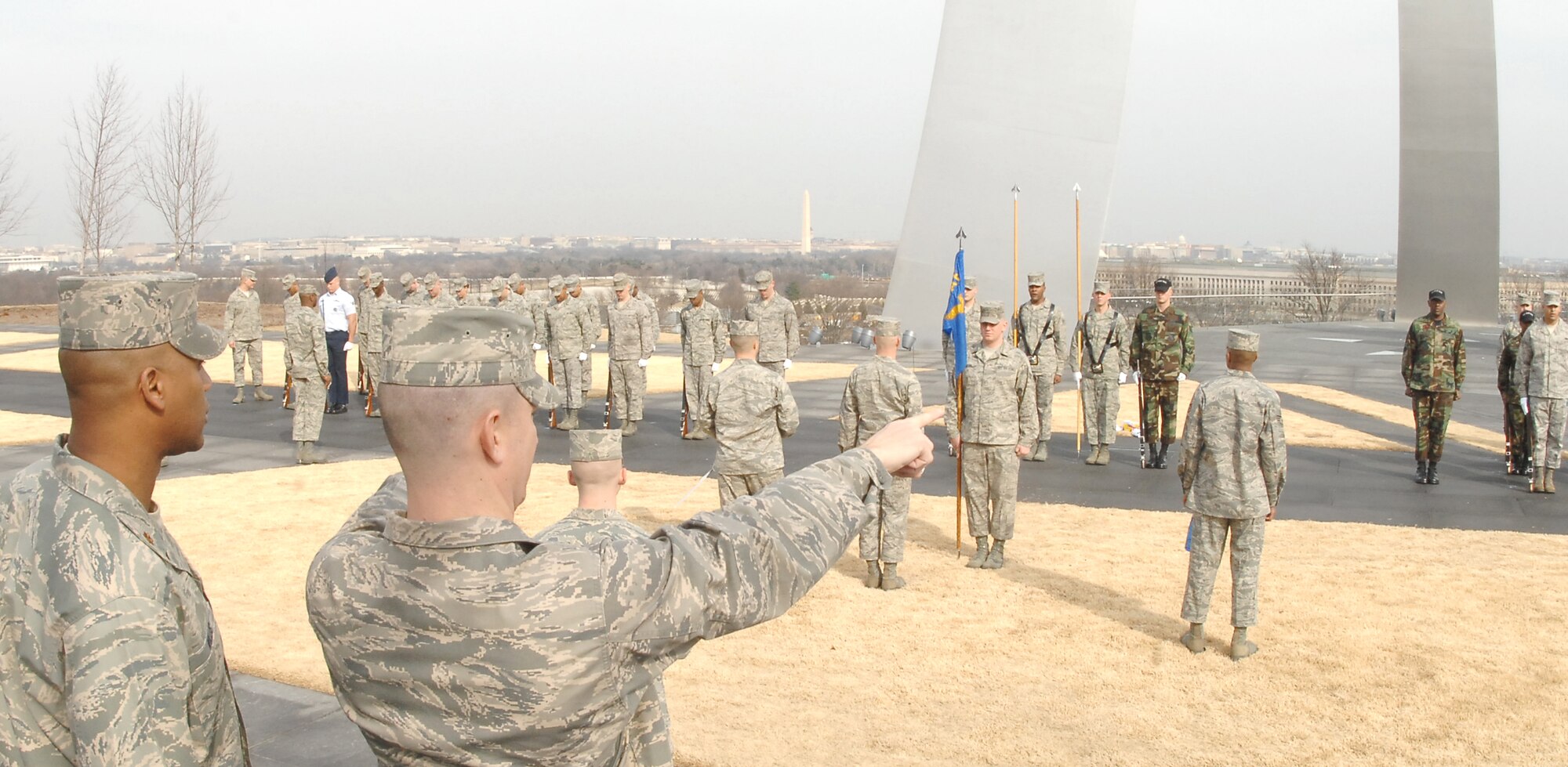 Capt. Brent Mundie, United States Air Force Honor Guard, directs  Airmen into their positions during training Feb. 10 at the National Air Force Memorial. More than 90 ceremonial guardsmen participated in the practice of the arrival and wreath laying ceremonies that will take place at the memorial through the year. The ceremonies are attended by senior military leaders from all over the world. (U.S Air Force photo by Senior Airman Alexandre Montes)