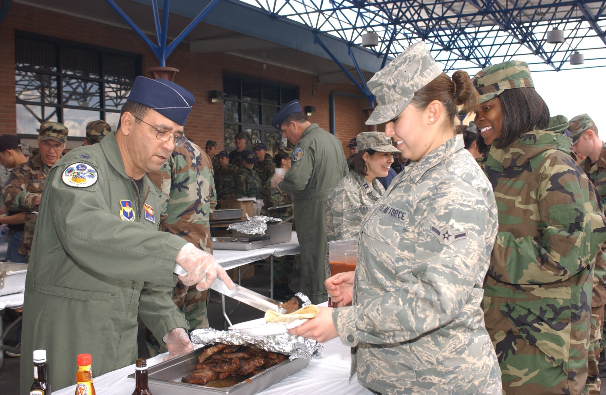 Col. Jose Salinas, 162nd Fighter Wing vice commander, serves a steak to Airman Laryssa Morales, Feb. 7, at the wing’s annual Steak Fry event for Airmen and retirees. The Steak Fry is paid for with donations from officers and senior enlisted members and brings the entire wing family together to share a lunch. (Air National Guard photo by Senior Airman Sara Elliott)