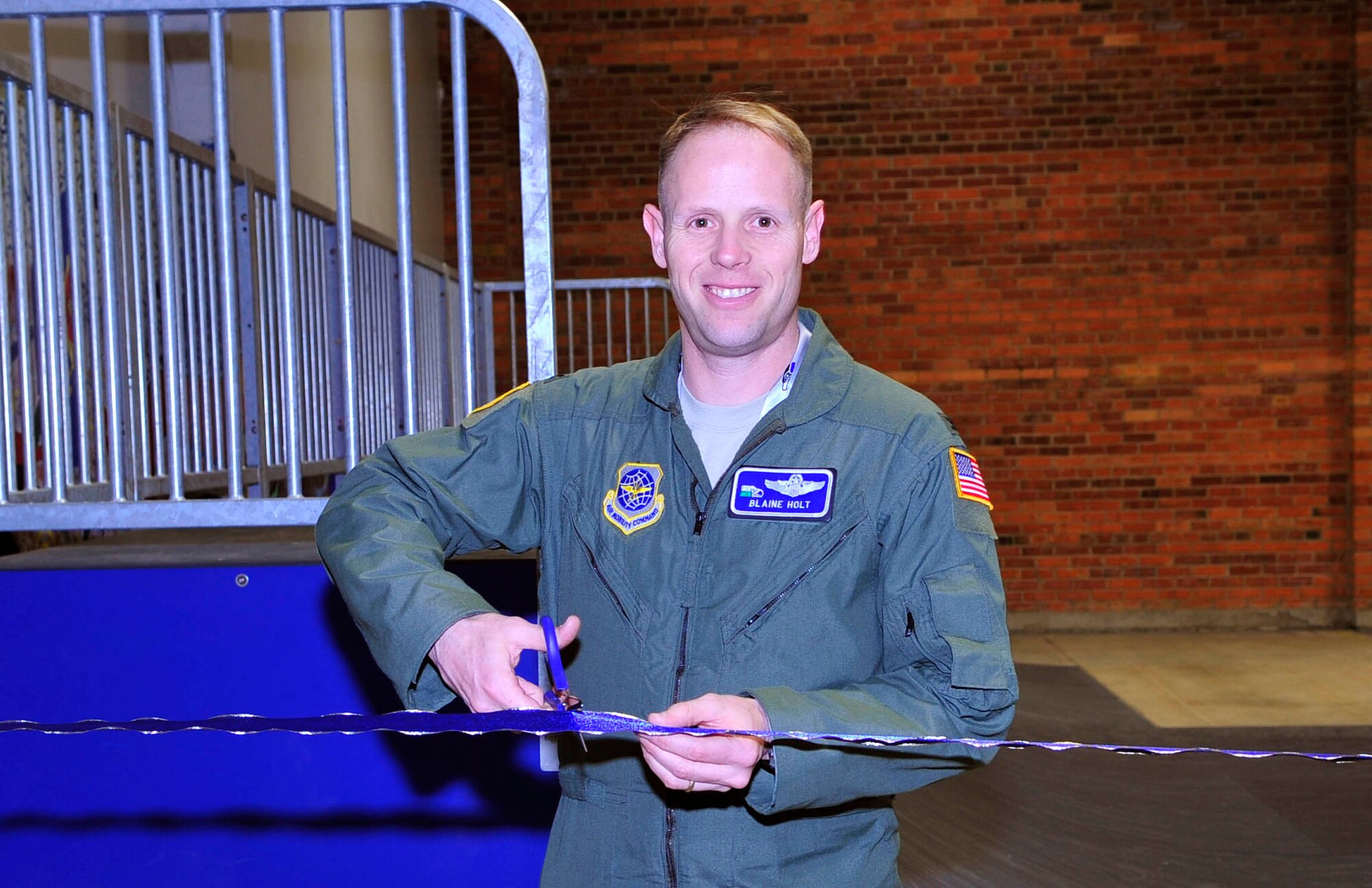 Col. Blaine Holt, 92nd Air Refueling Wing vice commander, cuts the ribbon during the ribbon cutting ceremony Feb. 10. The ceremony signified the official opening of the skate park located in the FunSpot. The park will give skaters a chance to skate safely on base. (U.S. Air Force photo / Staff Sgt. JT May III)