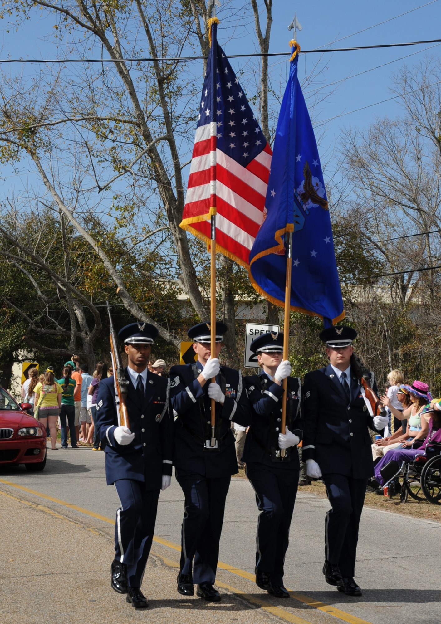 From left, Senior Airman William Raybon, Tech. Sgt. Homer Solis Jr. and Senior Airmen Ashley LeDuc and Brian Yoder march in the Elks Mardi Gras parade, Satur-day.  The honor guard was one of 72 units in the parade and was recognized as the top military entry.  For a schedule of upcoming Mardi Gras parades, see Page 27.
(U.S. Air Force photo by Kemberly Groue)