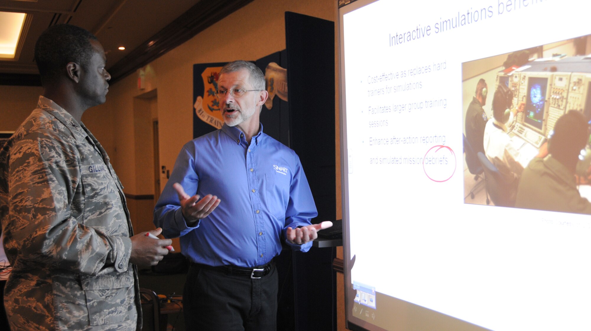Col. Prince Gilliard, left, 81st Training Group commander, talks to Gary Waliszewski about the benefits of smart board technology at the 14th annual Information Techno-logy Products and Services Expo Feb. 3 at the IP Casino Resort in Biloxi. Mr. Walis-zewski is regional manager for Smart Technologies federal systems group.  The expo was cosponsored by the 81st Training Support Squadron and the Armed Forces Com-munications and Electronics Association.  (U.S. Air Force photo by Kemberly Groue)