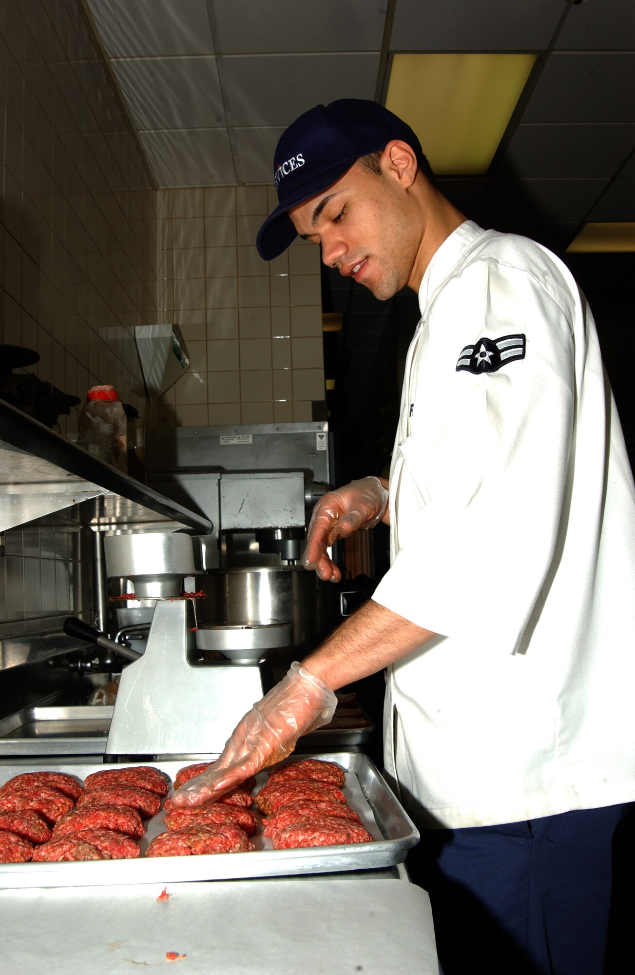SCOTT AIR FORCE BASE, Ill. -- Airman 1st Class Carlos Rodriguez, 375th Services Squadron services craftsman, adds seasoning to ground beef. (U.S. Air Force photo/Airman 1st Class Amber Kelly-Woodward)