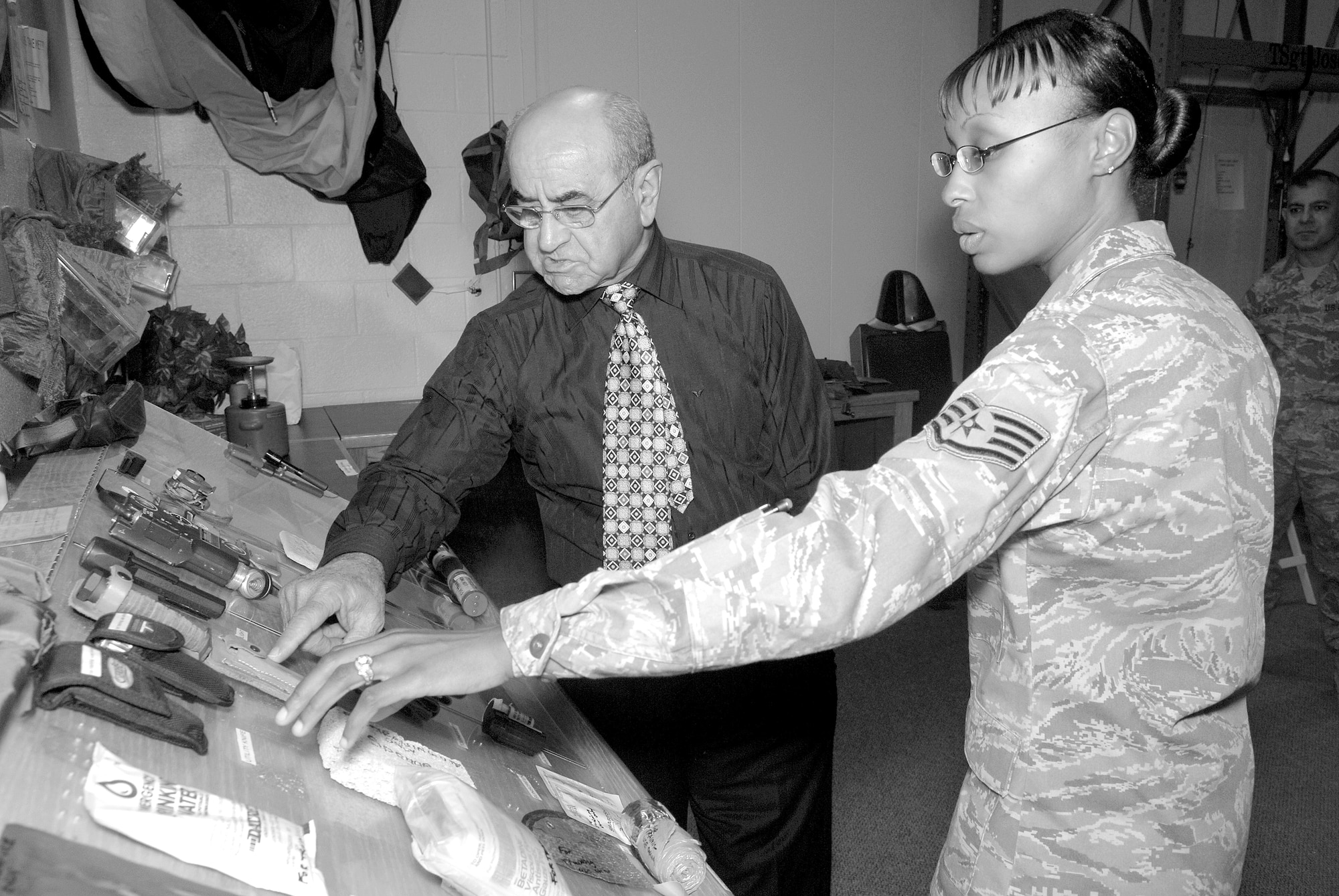 Maj. Gen. Georges Sada, former air vice marshal under Saddam Hussein, discusses the contents of the aircrew survival kit with Staff Sgt. Inisha George, 56th Operations Support Squadron aircrew flight equipment craftsman, Feb. 6. During his visit to Luke, General Sada spoke to Thunderbolts about his time working with Saddam Hussein and took a tour of the base. (U.S. Air Force photo/Staff Sgt. Ian Dean)
