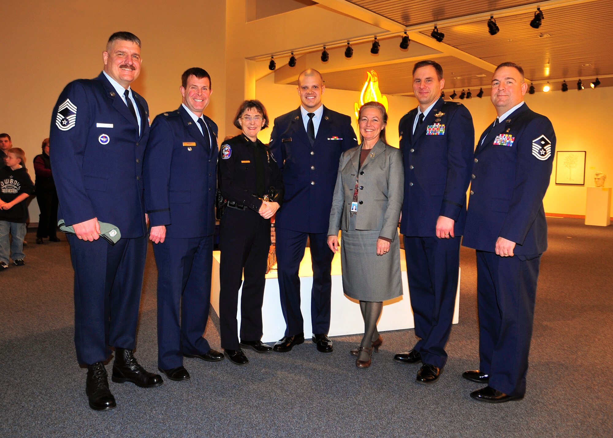 SPOKANE, Wash. – Members from the 336th Training Group, including Chief Master Sgt. Mark Berstler, superintendent, Lt. Col. Michael Poole, deputy commander, Airman David Scarlett, survival, evasion, resistance and evasion student, Lt. Col. John Holm, 66th Training Squadron commander, and Master Sgt. Kyle Liswig, 66 TRS first sergeant, stand for a picture with the Spokane Mayor, Mary Verner, and Spokane City Chief of Police, Anne Kirkpatrick, at the Spokane City Hall Feb. 9. Airman Scarlett was awarded the Life Saving medal for a heroic act that resulted in two saved lives. (U.S. Air Force photo / Senior Airman Joshua K. Chapman)