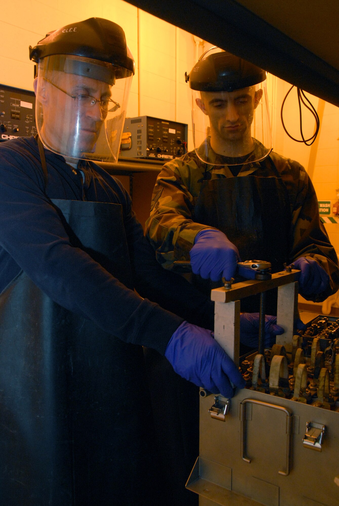 Master Sgt. Michael Bunting and Senior Airman David Stricker work together on removing a cell from an aircraft battery at the 437th Maintenance Squadron electrical and environmental battery shop Feb. 11. The shop is responsible for maintaining all the C-17 Globemaster III batteries for Charleston Air Force Base, S.C. Sergeant Bunting is an electrical and environmental systems craftsman for the 315th Maintenance Squadron and Airman Stricker is an electrical and environmental systems journeyman for the 437th MXS. (U.S. Air Force photo/Airman Ian Hoachlander)