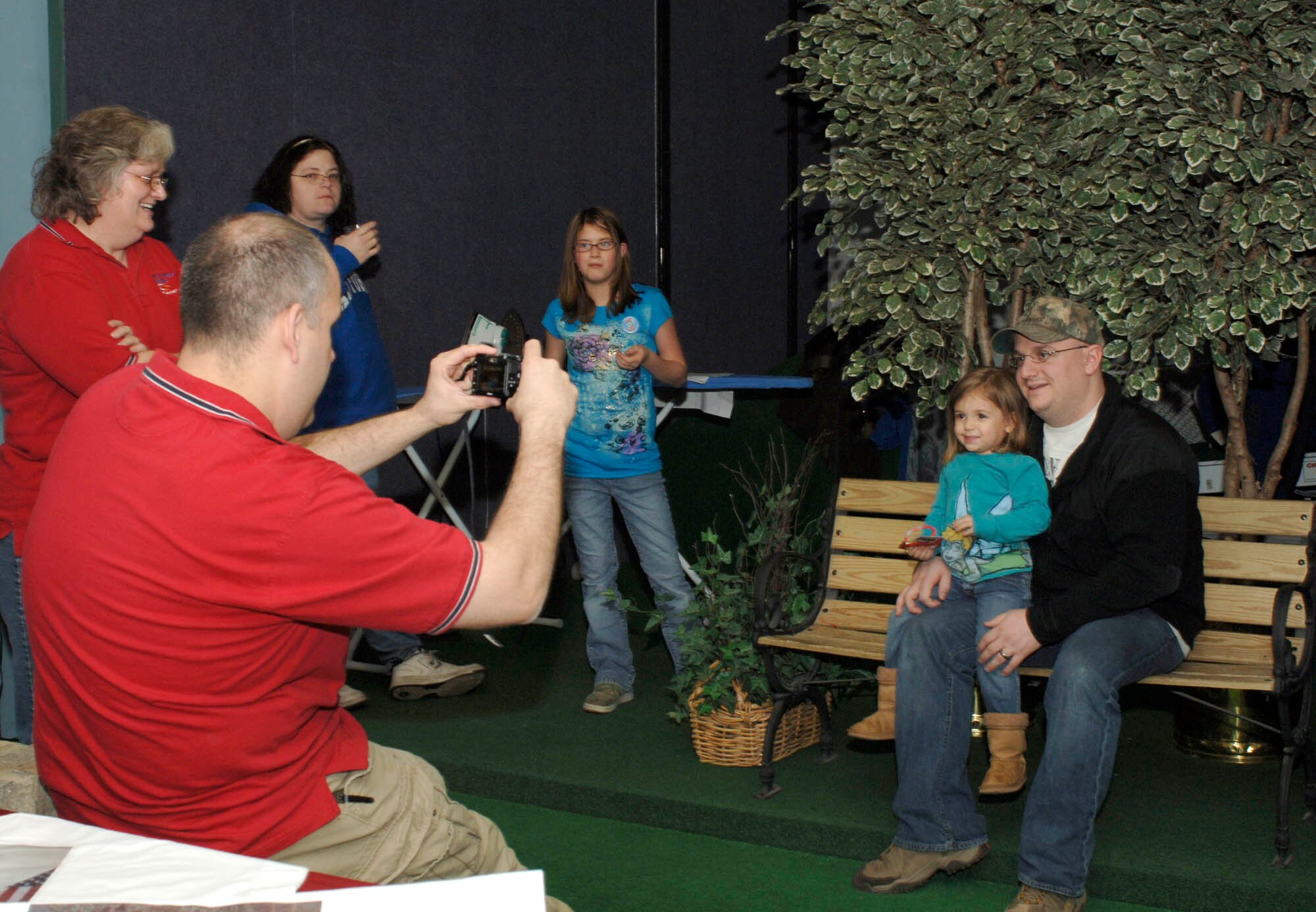 Staff Sgt. Keith Kramer 373 Training Squadron field training detachment instructor, and daughter Madelyn, 3, get their photo taken by Master Sgt. Scott Woller, 92nd Force Support Squadron Airman and Family Readiness Center superintendent, for Operation Pillowcase at the FunSpot Feb 7.  Operation Pillowcase is sponsored by Operation Spokane Heroes as relief for families dealing with deployment. It was just one of the many services provided during Operation Home Front. (U.S. Air Force photo / Airman 1st Class Darlene West)

