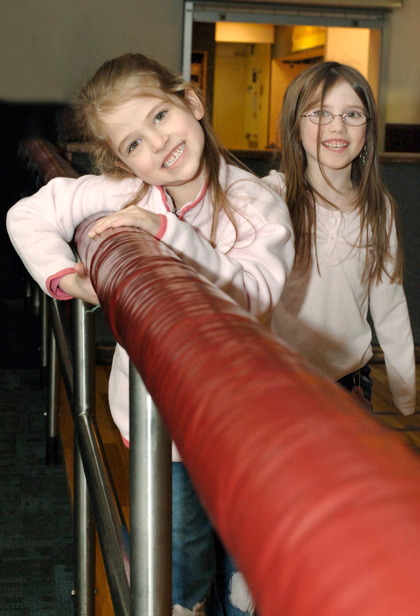 Savanna and Sarah, 6, pause for a photo during a roller-skating session at the FunSpot Feb 7.  The FunSpot provided free food and activities for families during Operation Home Front. (U.S. Air Force photo / Airman 1st Class Darlene West)