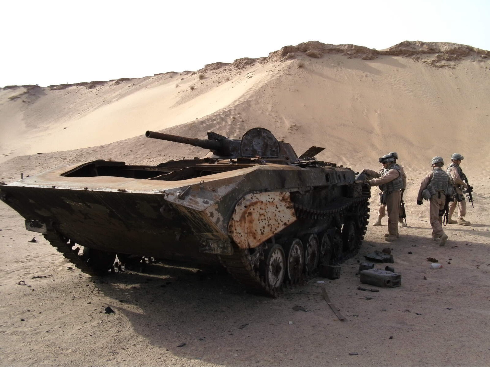 Security forces members get ready to conduct proficiency training on a destroyed Armored Personnel Carrier in a canyon range two miles north of their home base. (U.S. Air Force courtesy photo)       
