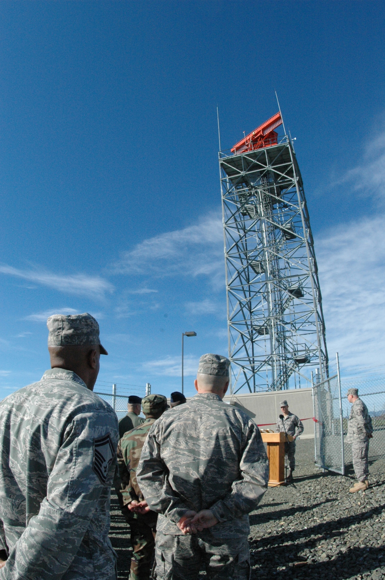 Members of the 60th Operations Support Squadron and 60th Communications Squadron look on as Col. Mark Dillon, 60th Air Base Wing commander speaks during a ribbon cutting ceremony to celebrate the opening of the new Digital Airport Surveillance Radar system. The DASR's digital capabilites provide timely and accurate information to Team Travis air traffic controllers and RAPCON personnel. (U.S. Air Force photo/Staff Sgt. Shaun Emery)