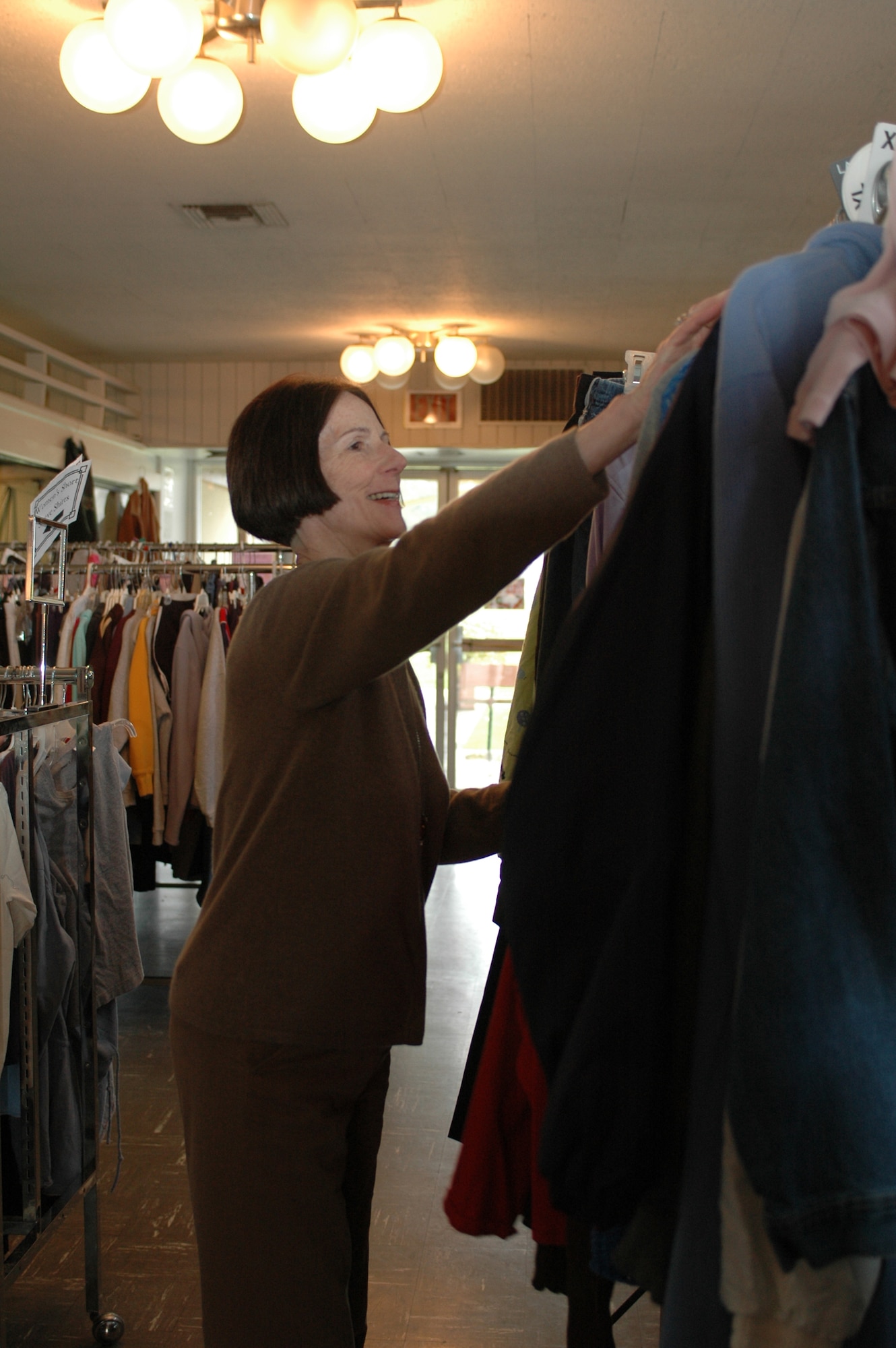Lois Horner arranges clothing Feb. 6 near the front entrance of the Thrift Shop at Travis Air Force Base, Calif. Ms. Horner, who typically helps sort and display clothing at the store, is one of its many volunteers. (U.S. Air Force photo/Nick DeCicco)