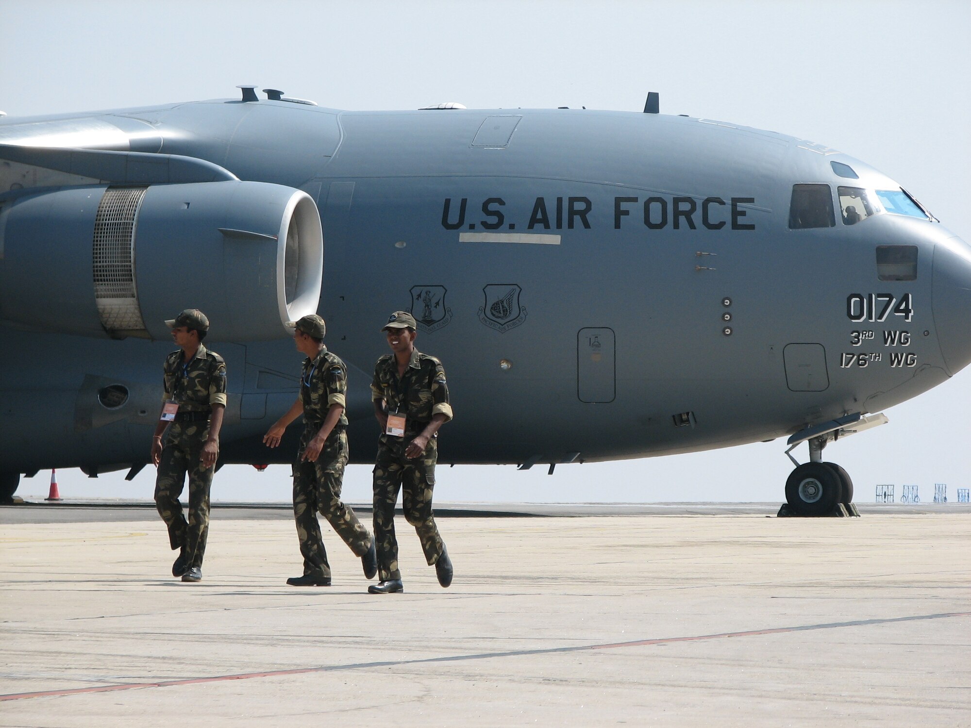 Airmen from the India air force walk past a C-17 Globemaster III Feb. 9 at the Aero India 09 Air Show at Air Force Station Yelahanka, India. The C-17, along with a C-130J Hercules, KC-135 Stratotanker, F-16 Fighting Falcon, F/A-18 Hornet and an Eagle Vision ground satellite system, are on hand at the air show, demonstrating U.S. capabilities and commitment to the Pacific region.(U.S. Air Force photo/Maj. Sam Highley)