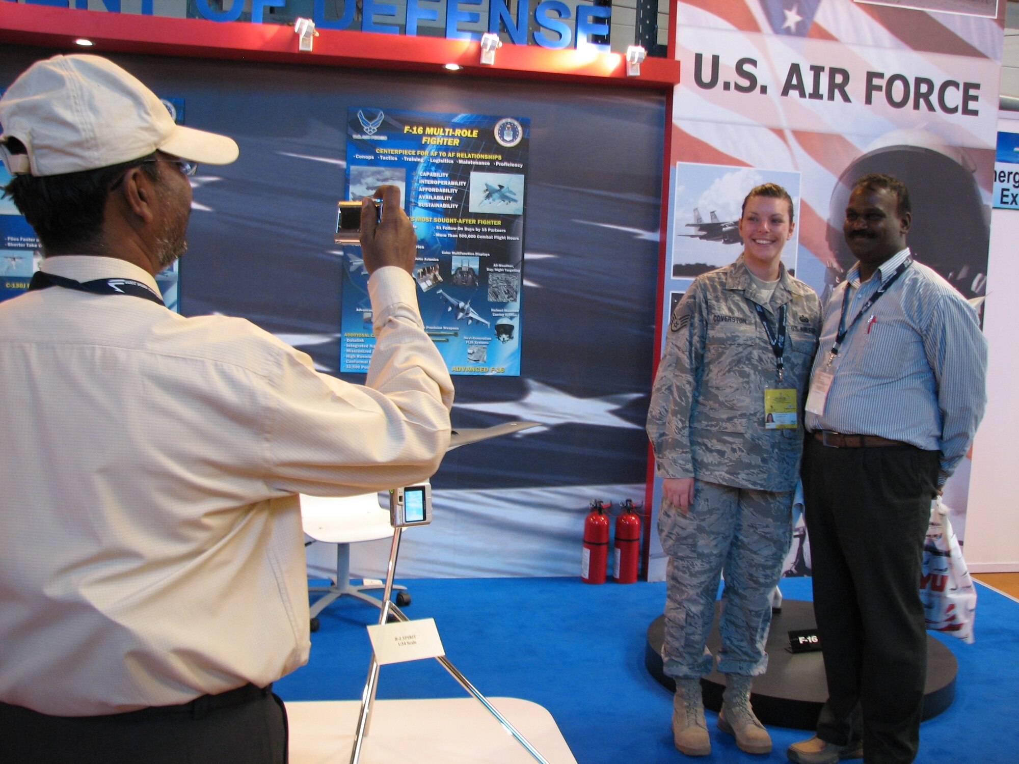 Staff Sgt. Marlena Coverston gets her photo taken with a visitor Feb. 11 at the Aero India 09 air show at Air Force Station Yelahanka, India. Sergeant Coverston and others from the Secretary of the Air Force Office of International Affairs talked to guests about the Air Force at the air show, which runs through Feb. 15. (U.S. Air Force photo/Maj. Sam Highley)
