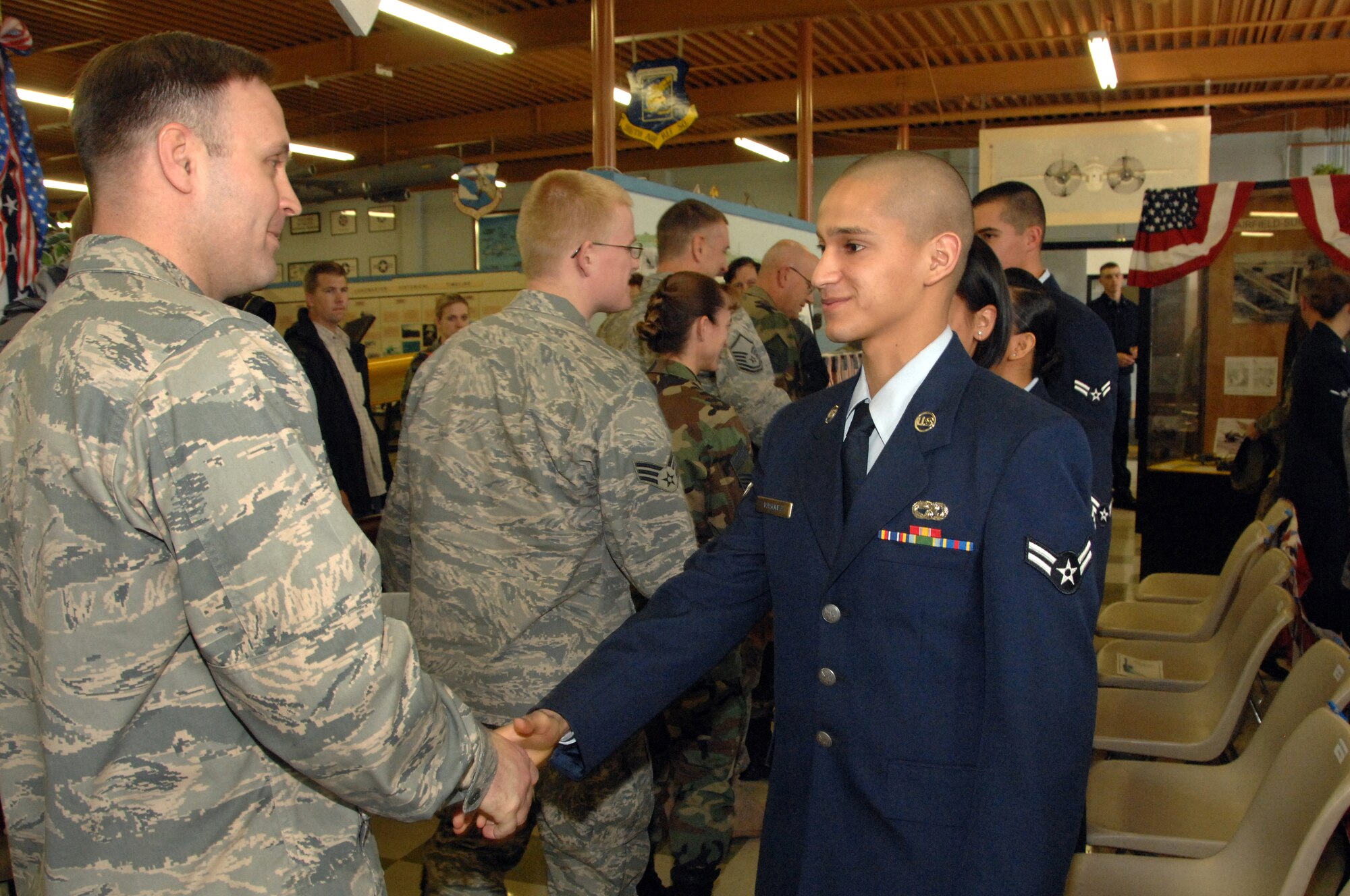 Airman 1st Class Juan Hernandez, 60th Aerial Port Squadron is congratulated by Lt. Col. Robert Charlesworth, 60th APS commander, following Airman Hernandez's naturalization ceremony Feb. 7. (U.S. Air Force photo by Civ/Nan Wylie) 