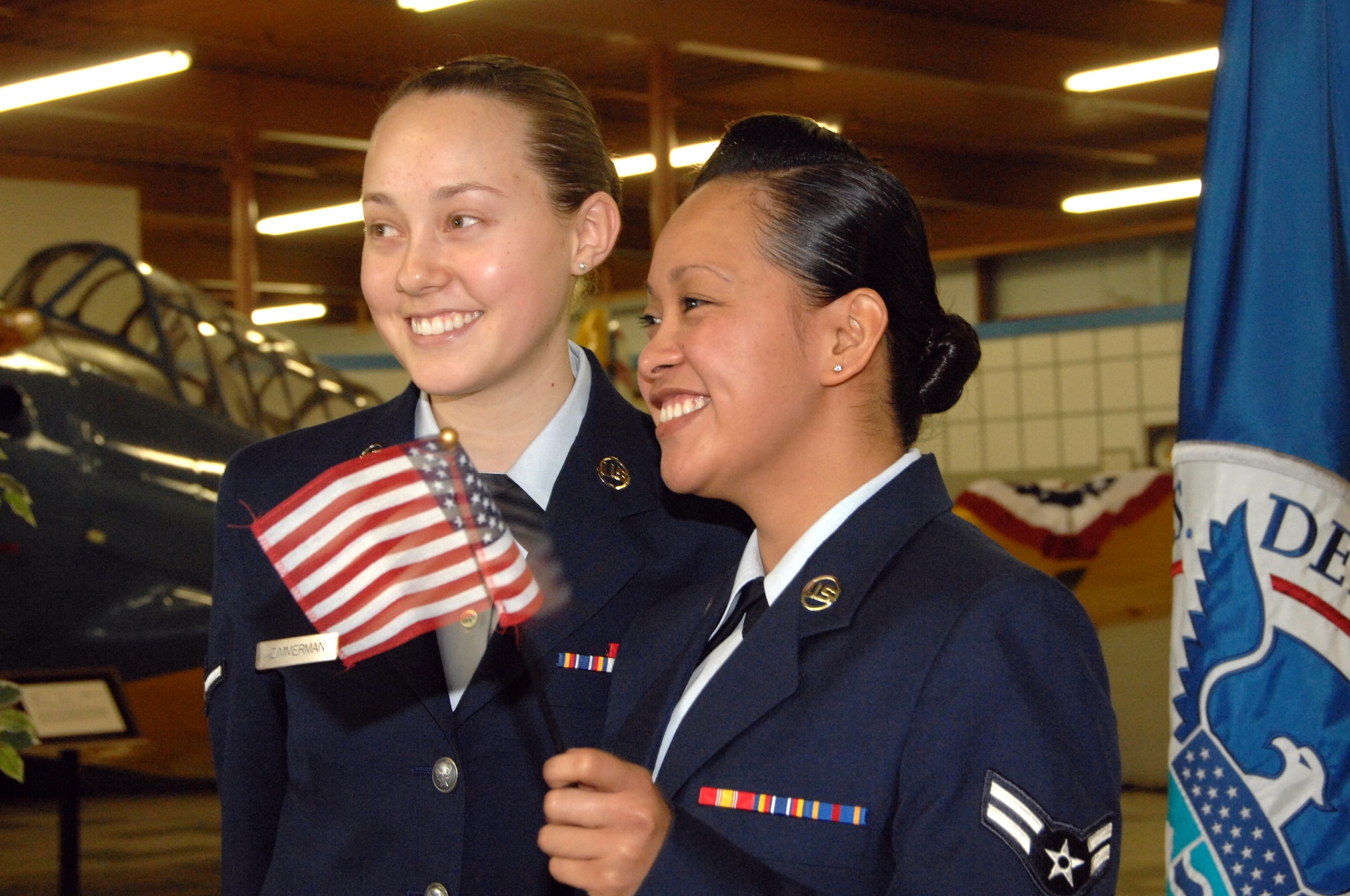 Airman 1st Class Vicky Roselle Guzman Santos, left, poses for pictures with her friend Airman Danielle Zimmerman following her naturalization ceremony Feb. 6 at the Travis Air Museum. (U.S. Air Force photo by Civ/Nan Wylie) 