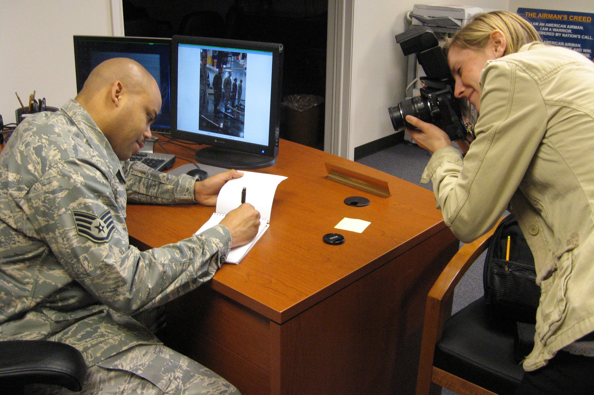 Kara Wilson (right) from Hirschi High School explores photography techniques and newspaper planning while shadowing 82nd Training Wing Public Affairs Staff Sgt. Vernon Cunningham during the annual Groundhog Job Shadow event.  More than 30 students from North Texas high schools shadowed military and civilian Airmen to learn more about future careers. (U.S. Air Force photo/Debi Smith)