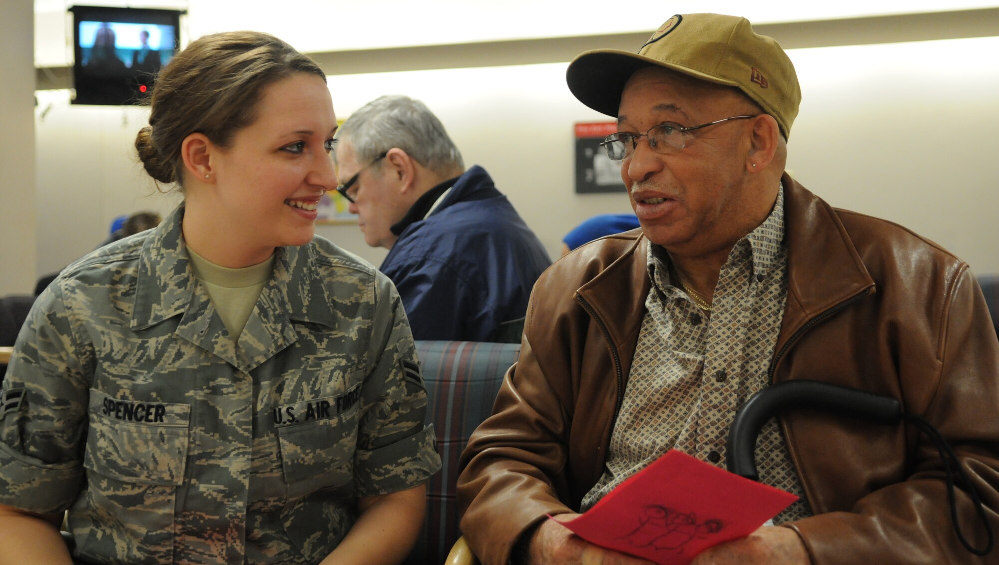 Airman 1st Class Amber D. Spencer, 579th Medical Group, talks with a veteran Feb. 9 at the Baltimore Veterans Affairs Medical Center. More than 35 Bolling and Pentagon Airmen visited the hospital to spend time with the patients, and hand out T-shirts and Valentine’s Day cards. (U.S. Air Force photo by Senior Airman R. Michael Longoria)