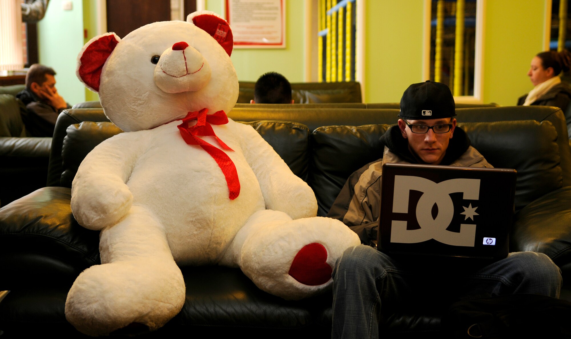 Why look on the Internet when the perfect Valentine's Day gift is closer than you may know?  The Bob Hope Community Center at RAF Mildenhall is now selling various Valentine's Day gifts priced $5 and up, including the big stuffed bear sitting next to Senior Airman Ian Metz of the 100th Air Refueling Wing.  While you're there you can also enjoy coffee or snacks from the Daily Grind coffee bar. (U.S. Air Force illustrative photo by Senior Airman Christopher L. Ingersoll)