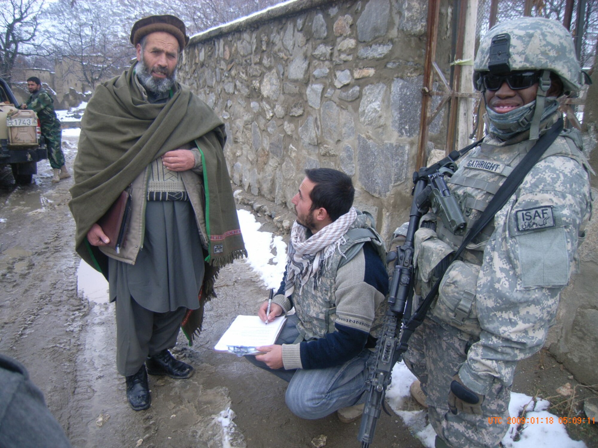 The 72nd Security Force Squadron has a small team in Afghanistan, working with the Army, providing security to Civil Affairs efforts which provide humanitarian aid and other services for villages in Afghanistan. Senior Airman Kristopher Gathright is pictured providing security during a humanitarian aid drop in Nijrab, Afghanistan. (Air Force photo)