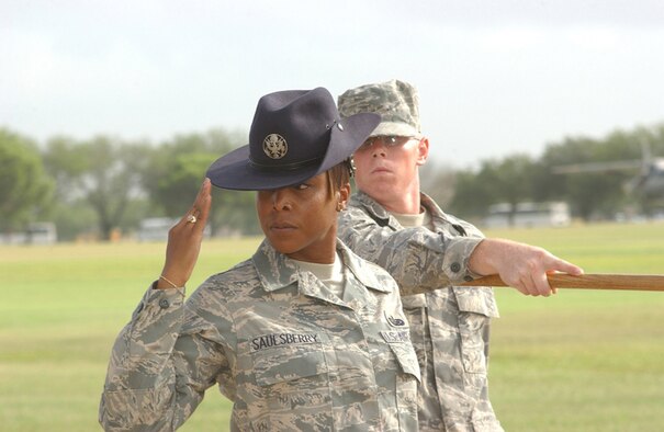 Staff Sgt. Nicole Saulsberry, a military training instructor with the 323rd Training Squadron, and her flight pass in review during a Basic Military Training graduation ceremony July 25, 2008, at Lackland Air Force Base, Texas. Those interested in becoming a military training instructor can attend a briefing at RAF Mildenhall May 28. See story for additional information.  (U.S. Air Force photo by Alan Boedeker)                      