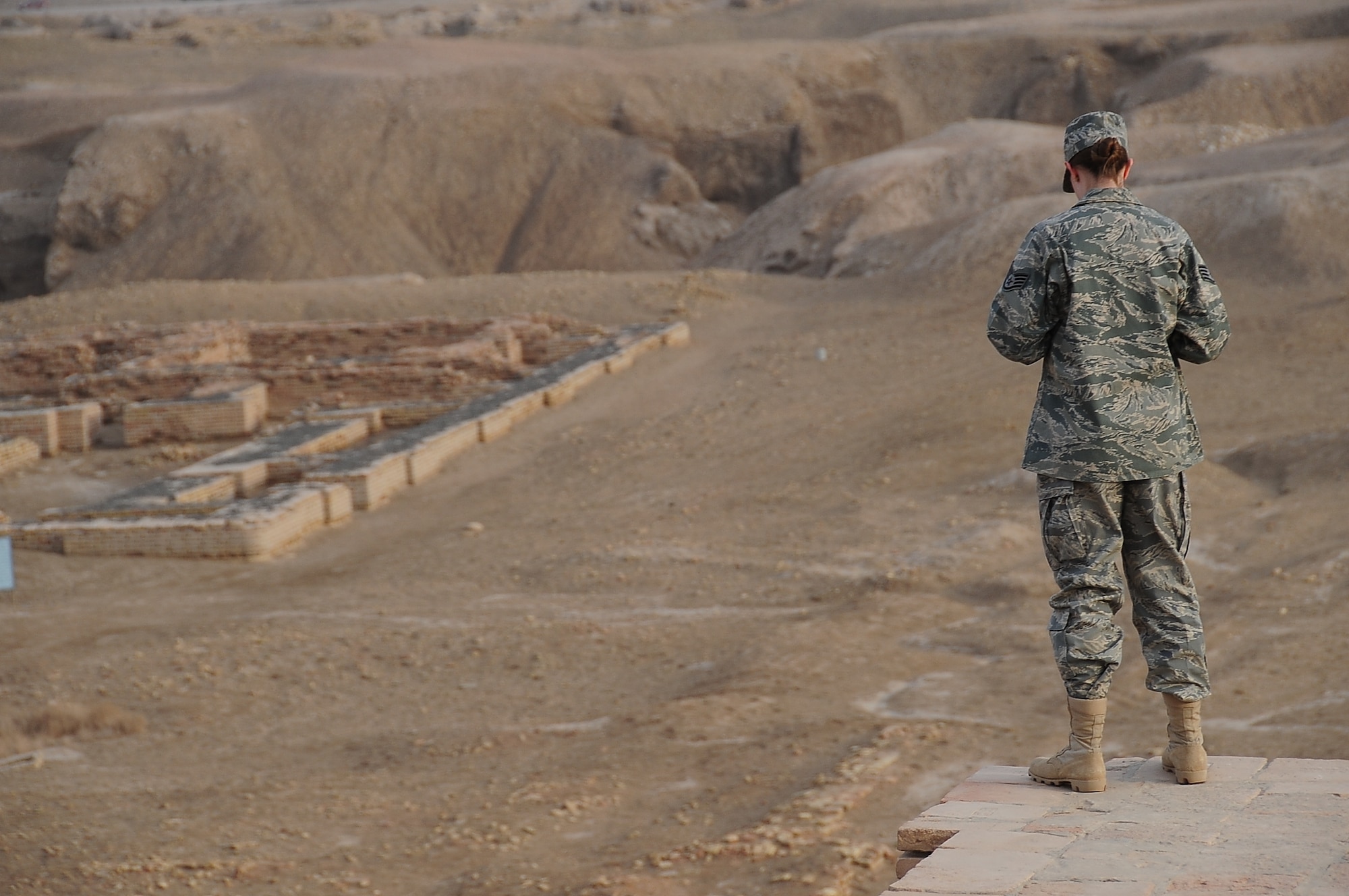 ALI BASE, Iraq – Staff Sgt. Ariel Sauvey, 407th Expeditionary Operation Support Squadron, takes in the view of the ruins of King Shulgi’s palace from atop the Great Ziggurat of Ur Feb. 9. The Ziggurat construction was finished in the 21st century B.C. by King Shulgi in the ancient city of Ur, which is near An Nasiriyah in present-day Iraq. Members of the 407th Air Expeditionary Group Chaplains Office offer three tours weekly of the Ziggurat and ruins of the city of Ur.  Sergeant Sauvey is deployed to Ali from the 78th Operation Support Squadron, Robins Air Force Base, Ga., and hails from Greenville, Ohio.  (U.S. Air Force photo/Staff Sgt. Christopher Marasky)