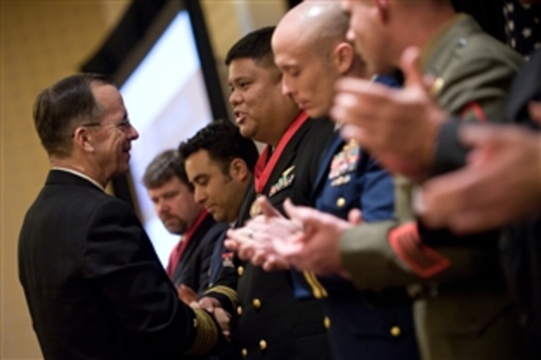 U.S. Navy Adm. Mike Mullen, chairman of the Joint Chiefs of Staff, presents Lt. Cmdr. Daniel D. Imbat with the National Defense Industrial Association 20th Annual Special Operations/Low Intensity Conflict Symposium and Exhibition Achievement Award, Marriott Wardman Park, Washington, D.C., Feb. 11, 2009. Imbat introduced the first U.S. Naval Special Warfare unmanned aerial vehicle squadron in Al Asad and Fallujah, Iraq. 