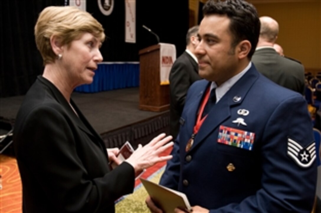 Deborah Mullen, wife of Chairman of the Joint Chiefs of Staff U.S. Navy Adm. Mike Mullen, speaks with U.S. Air Force Staff Sgt. Robert Gutierrez at the National Defense Industrial Association 20th Annual Special Operations/Low Intensity Conflict Symposium and Exhibition Award Banquet, Marriott Wardman Park, Washington, D.C., Feb. 11, 2009. Gutierrez, a special tactics air combat controller, repelled an attack of over 240 enemy combatants in Afghanistan in 2008, saving his unit.