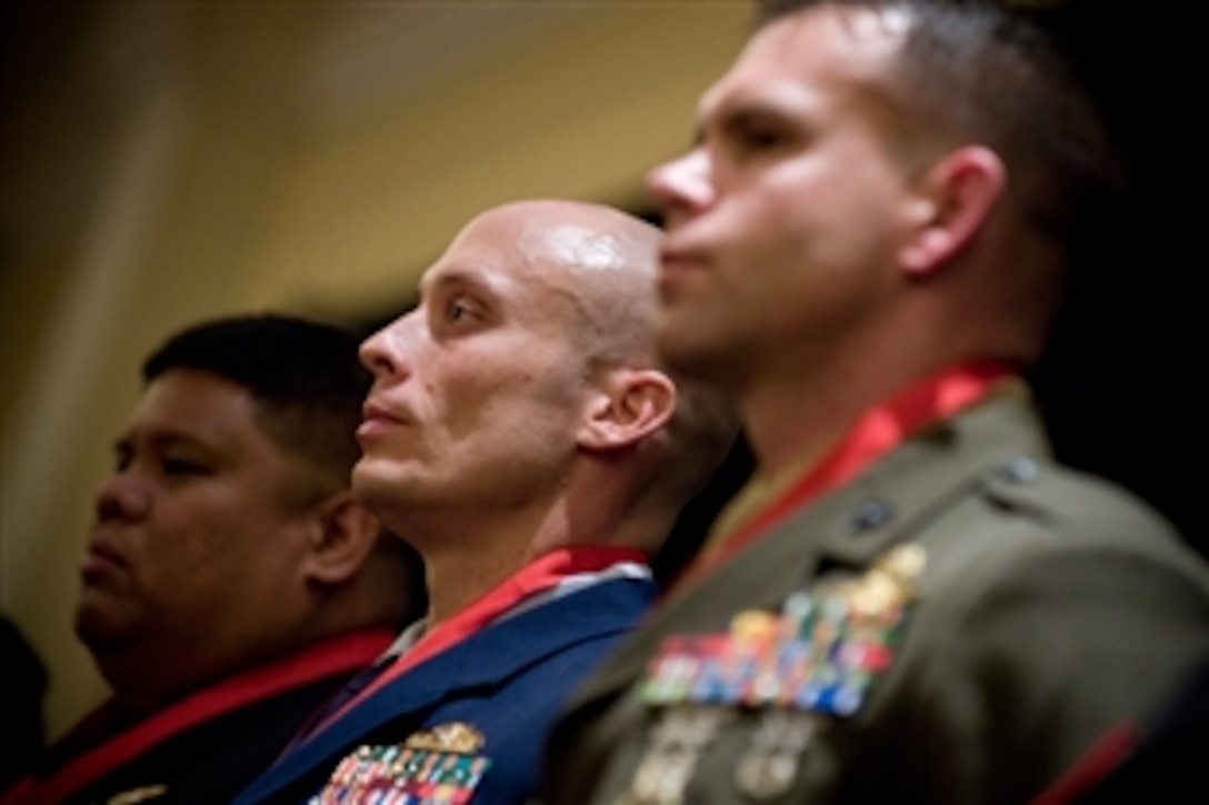 U.S. Navy Lt. Cmdr. Daniel D. Imbat, U.S Coast Guard Lt.j.g. Paul M. Leon and U.S. Marine Gunnery Sgt. John. S. Mosser receive the National Defense Industrial Association 20th Annual Special Operations/Low Intensity Conflict Symposium and Exhibition Achievement Award, Marriott Wardman Park, Washington, D.C., Feb. 11, 2009. The awards are in recognition of those who have made significant and lasting contributions in the areas of special operations or low intensity conflict.
