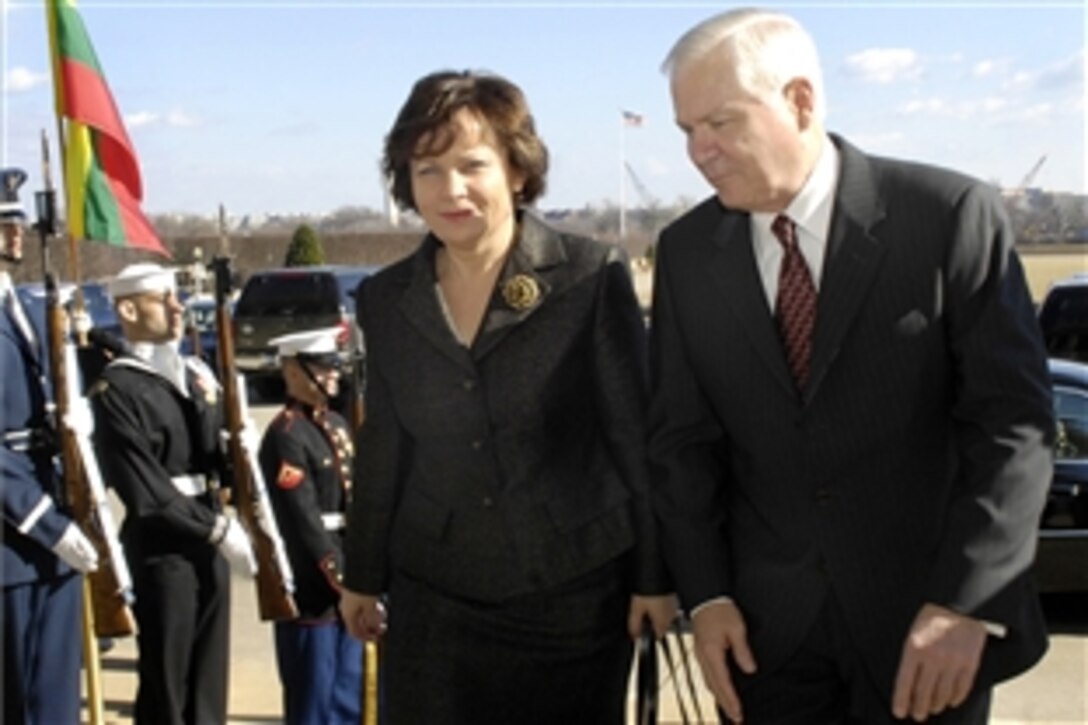 Defense Secretary Robert M. Gates, right, escorts Lithuanian Minister of Defense Rasa Jukneviciene through an honor cordon to discuss bilateral defense issues at the Pentagon, Feb. 12, 2009.  