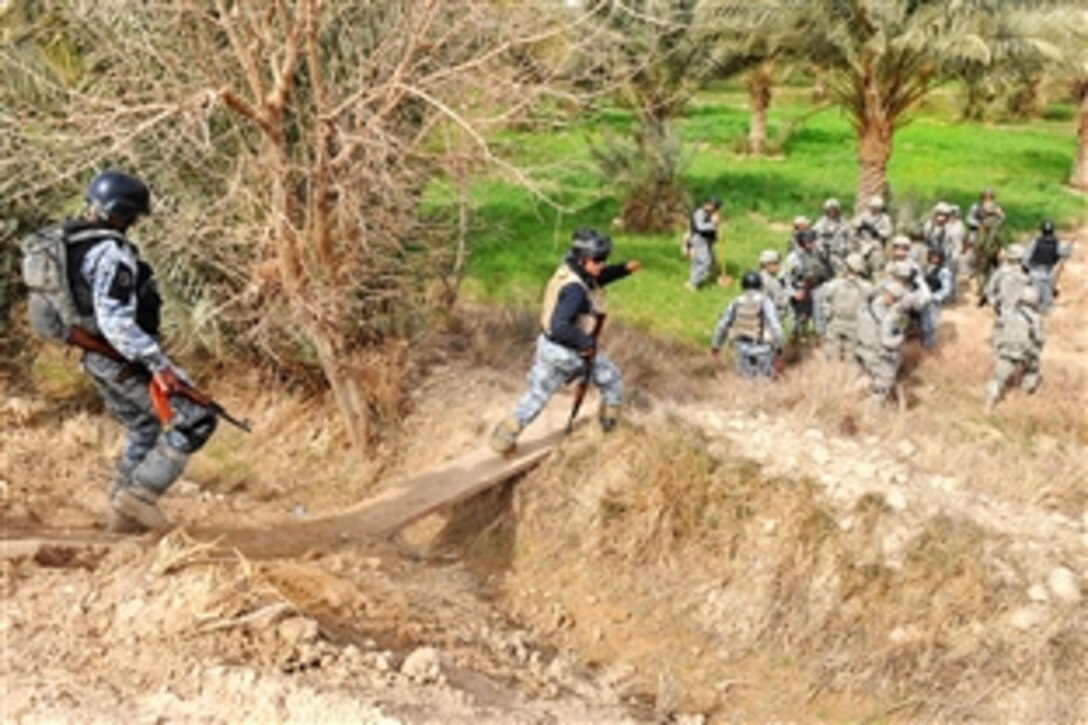U.S. Army soldiers and Iraq National Police officers search for suspected weapons caches during Operation Doubleday in the New Baghdad district of eastern Baghdad, Iraq, Feb. 9, 2009. 
The soldiers are assigned to the 82nd Airborne Division's Company A, 2nd Battalion, 505th Parachute Infantry Regiment, 3rd Brigade Combat Team.