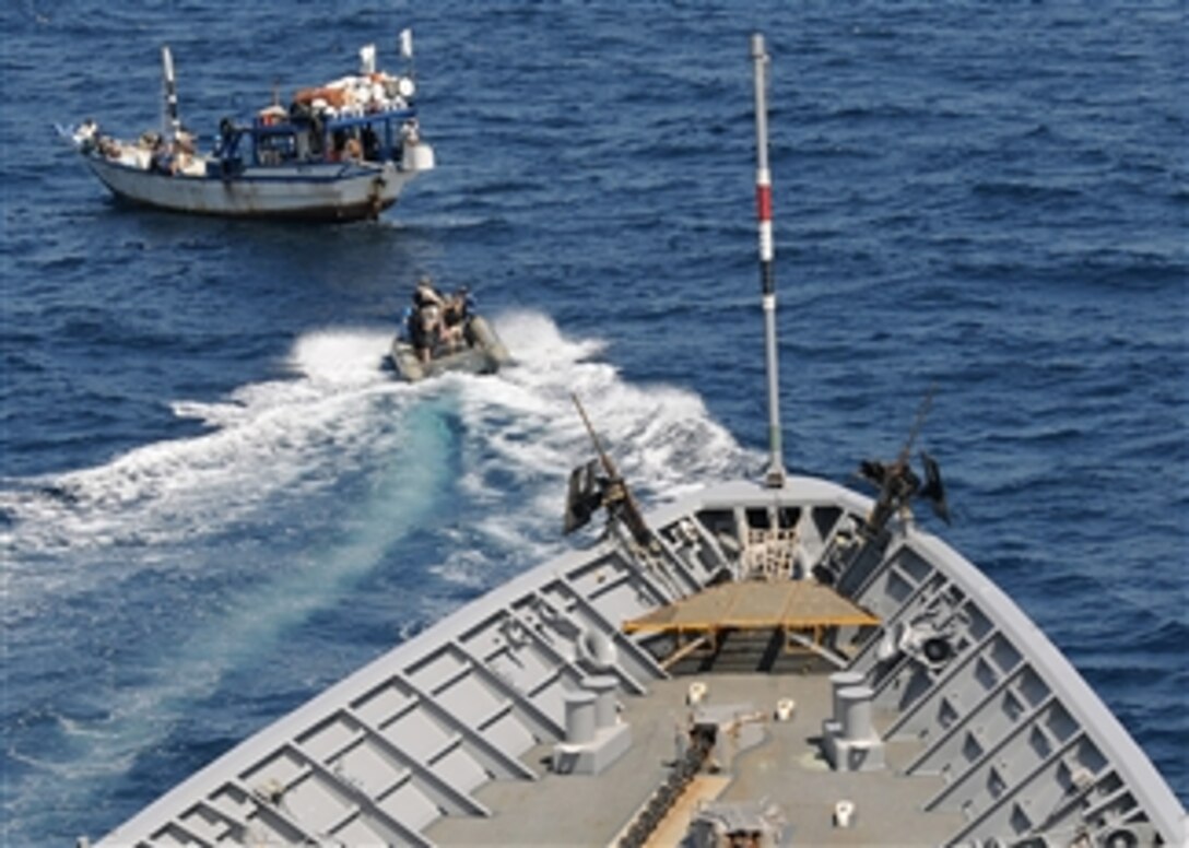 U.S. Navy sailors assigned to the guided-missile cruiser USS Vella Gulf (CG 72) underway in the Gulf of Oman use a rigid-hulled inflatable boat to approach a dhow that needs assistance.  The sailors boarded the dhow, a lateen-rigged boat, to help local fishermen repair their boat's engine.  The Vella Gulf is the flagship for Combined Task Force 151, a multinational task force that detects and combats piracy in and around the Gulf of Aden, Arabian Gulf, Indian Ocean and Red Sea.  