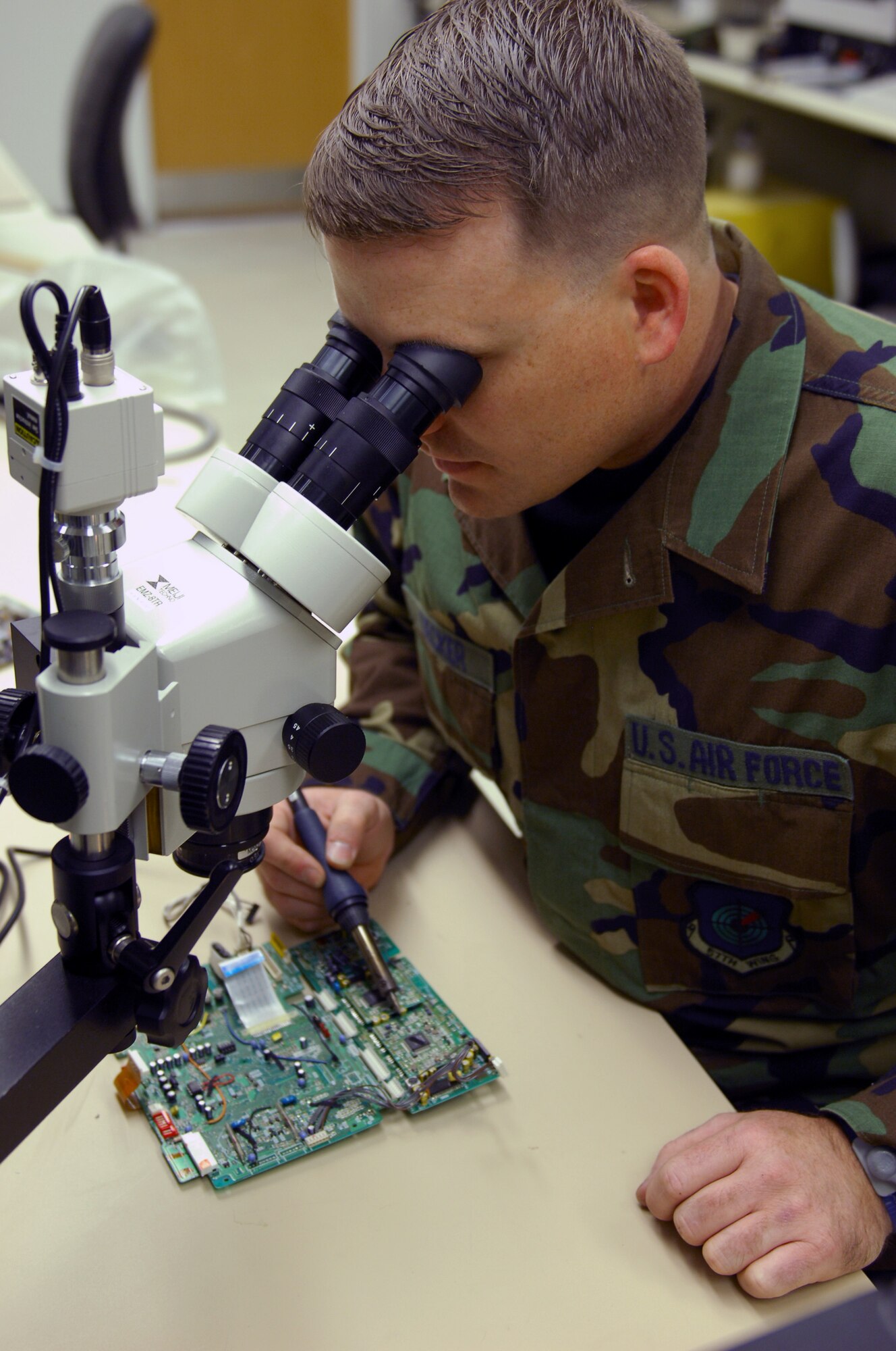 Tech. Sgt. David Decker, Air Force Repair Enhancement Program technician, repairs a component on a circuit card assembly of an eight-millimeter aircraft recorder Feb. 6 here. Sergeant Decker has a miniature micro-soldering certification and can repair parts as small as a 120-pin microchip. 
(U.S. Air Force photo by Staff Sgt. Erin T. Worley)